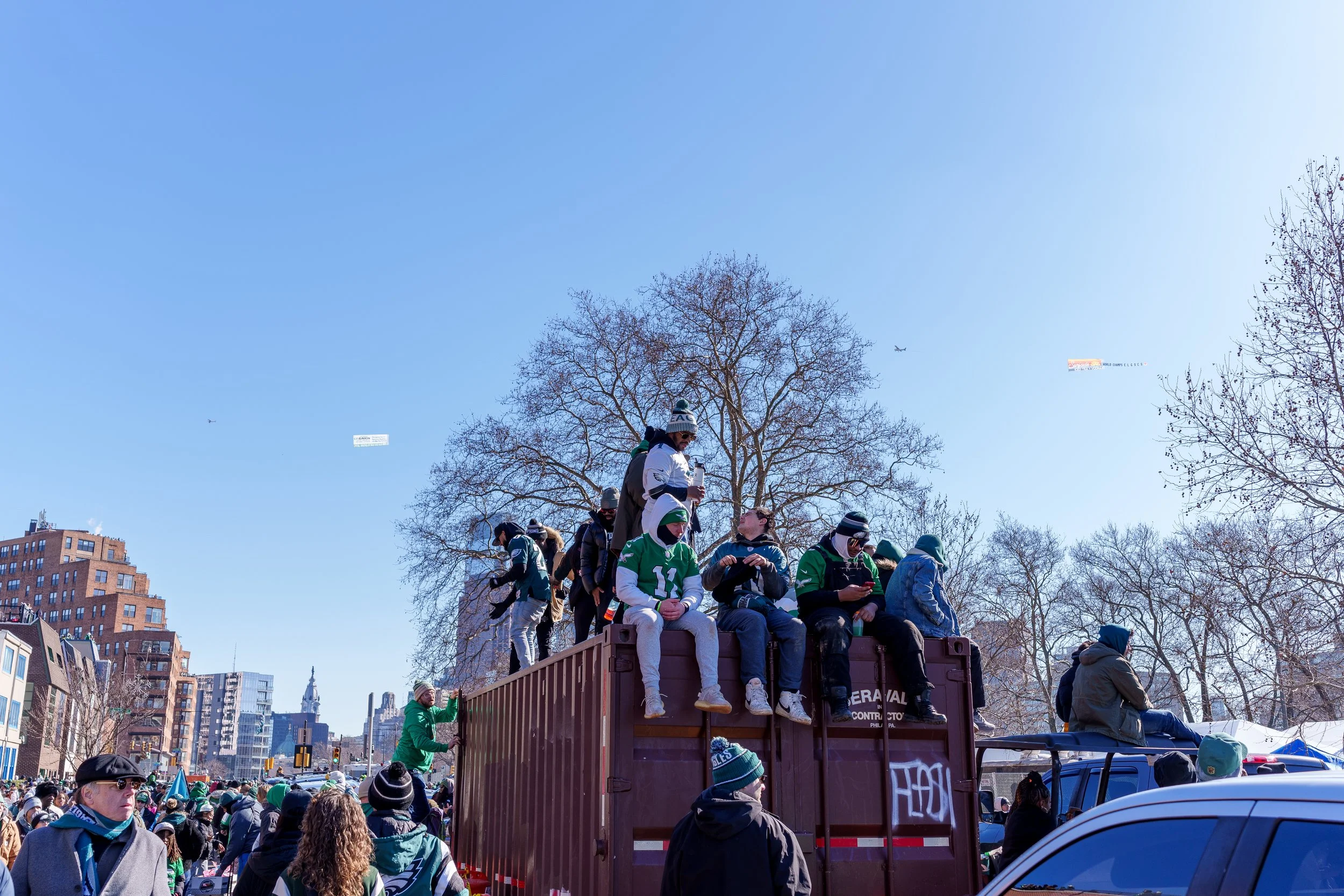 Fans climbing a container for a view over the crowd