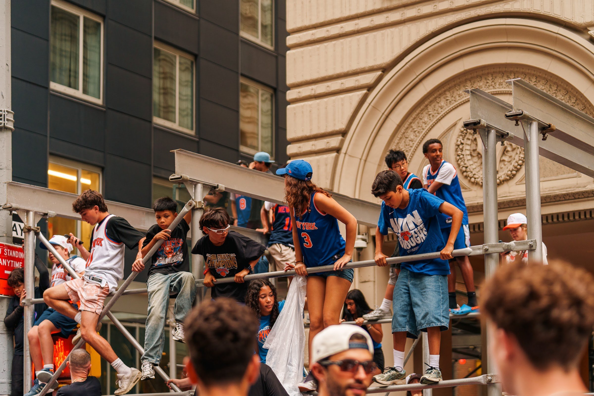 Young fans climbing the scaffolding for a better view