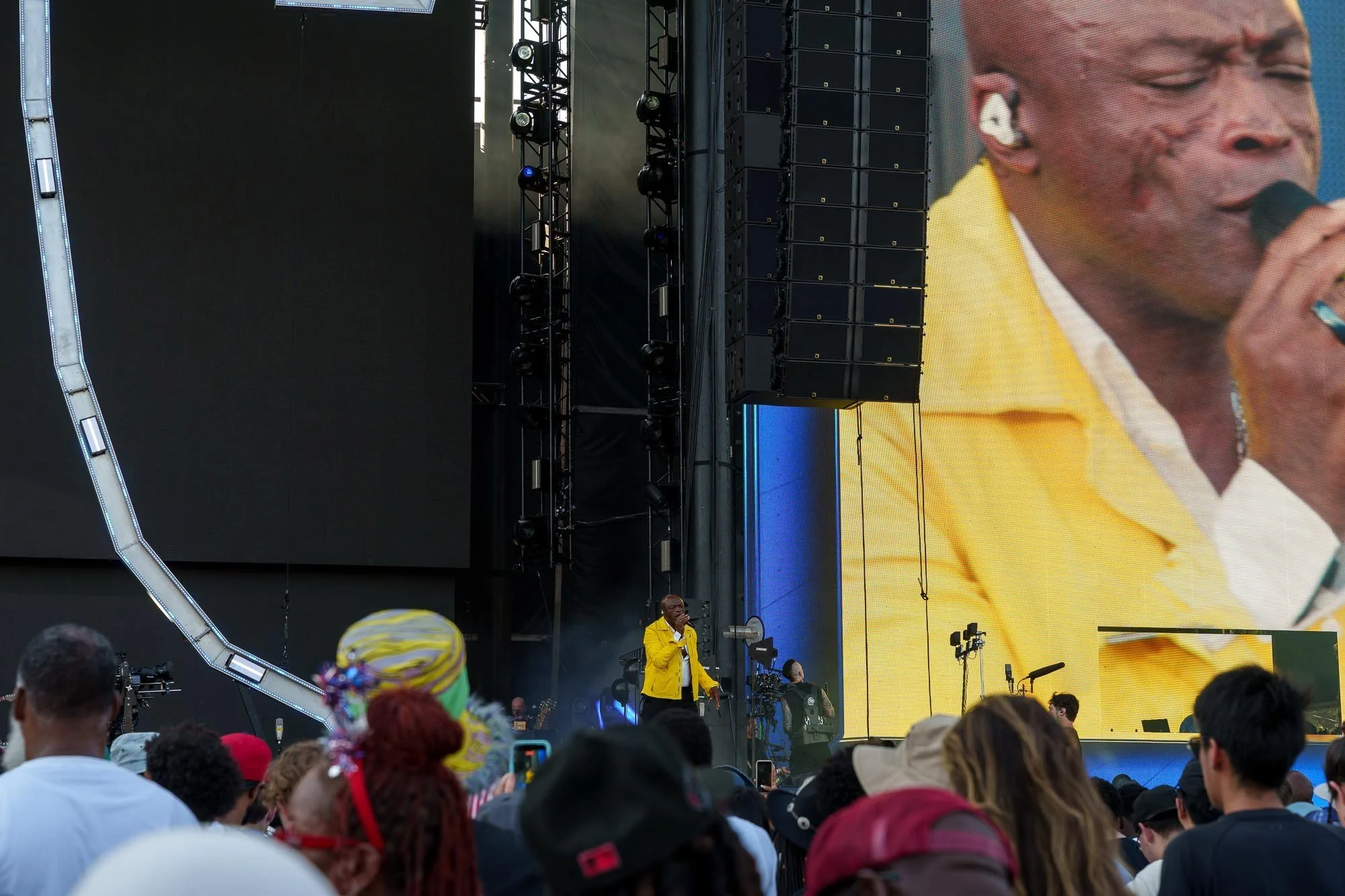 A performer on the screens above the crowd