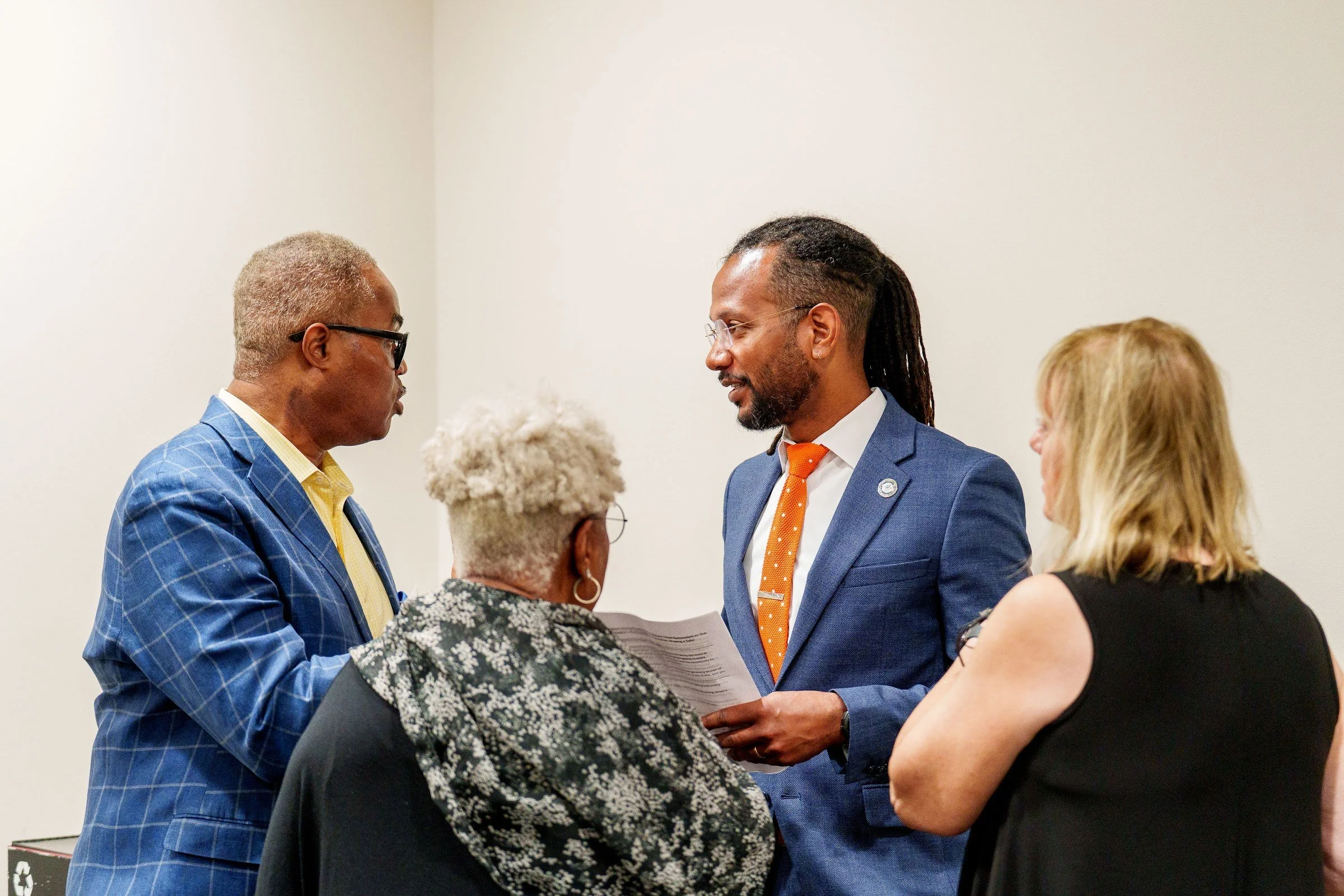 Leaders greeting a guest between sessions