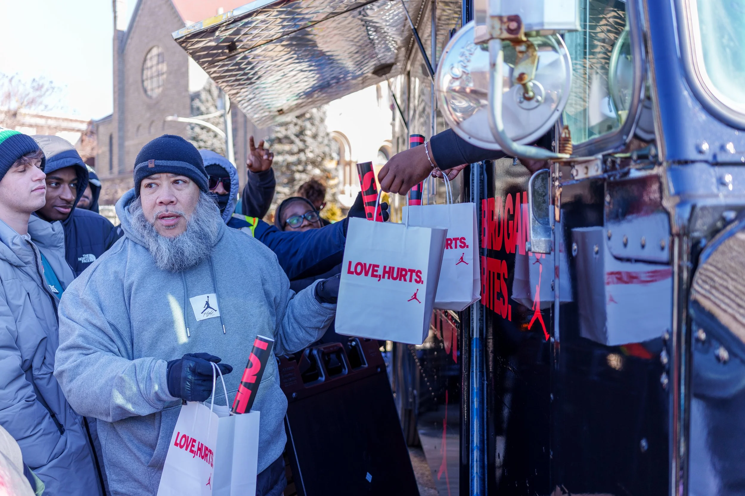 Fans collecting Love, Hurts. merchandise at the truck window