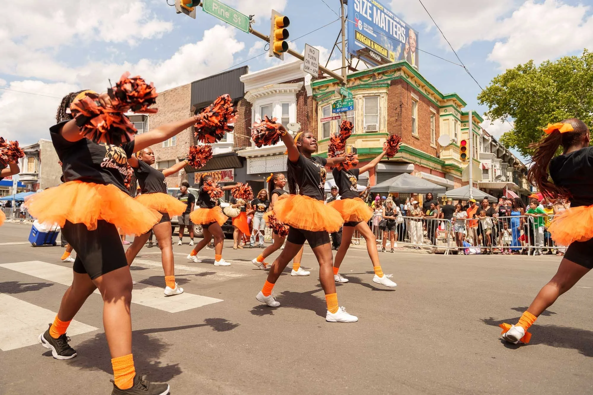 Dancers in orange leading the Juneteenth parade