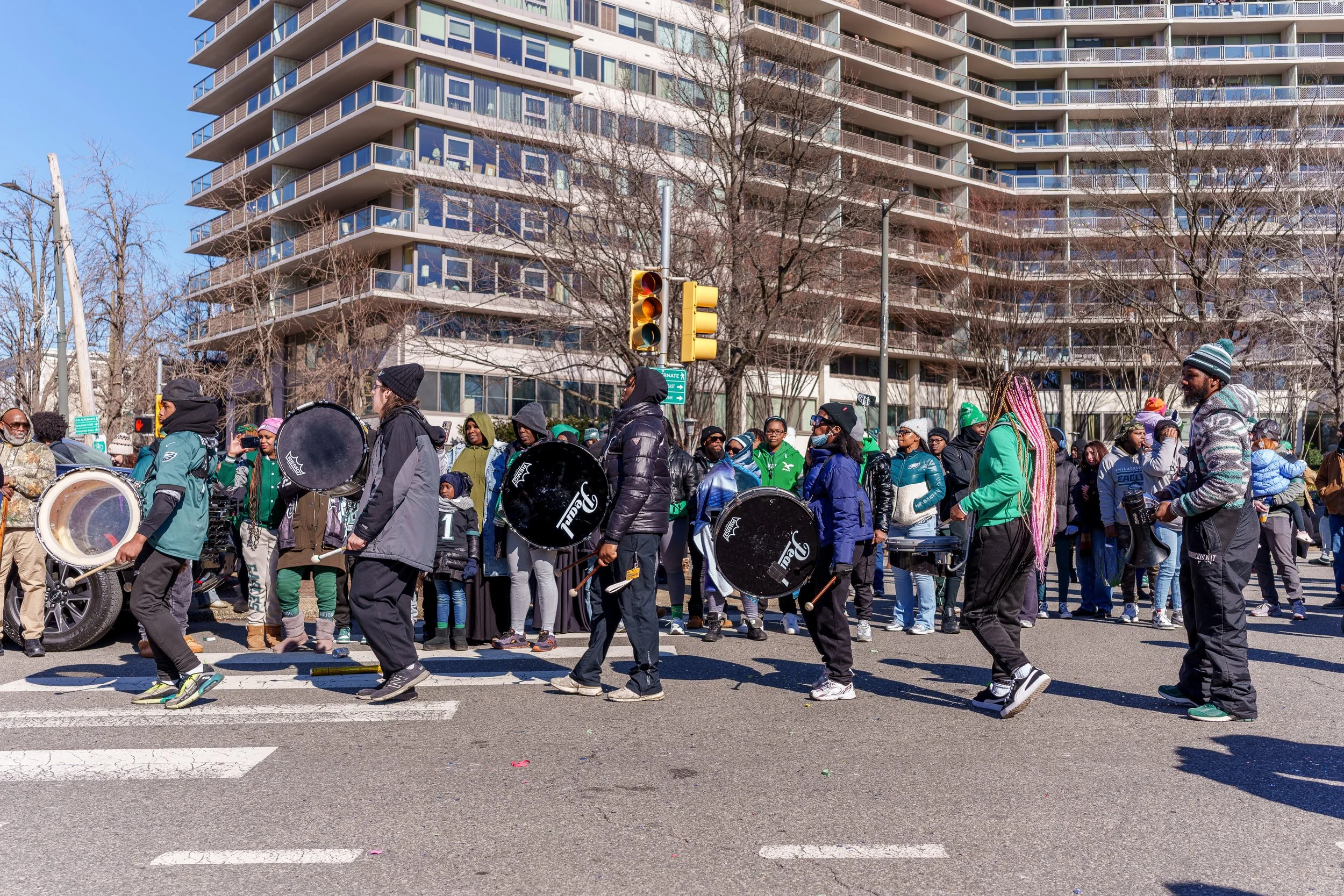 Drumline and crowd moving down the street