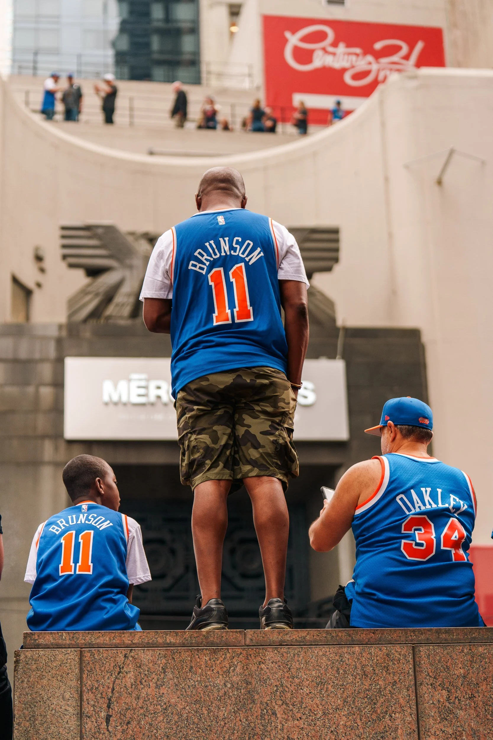 A fan in a Brunson jersey watching the parade