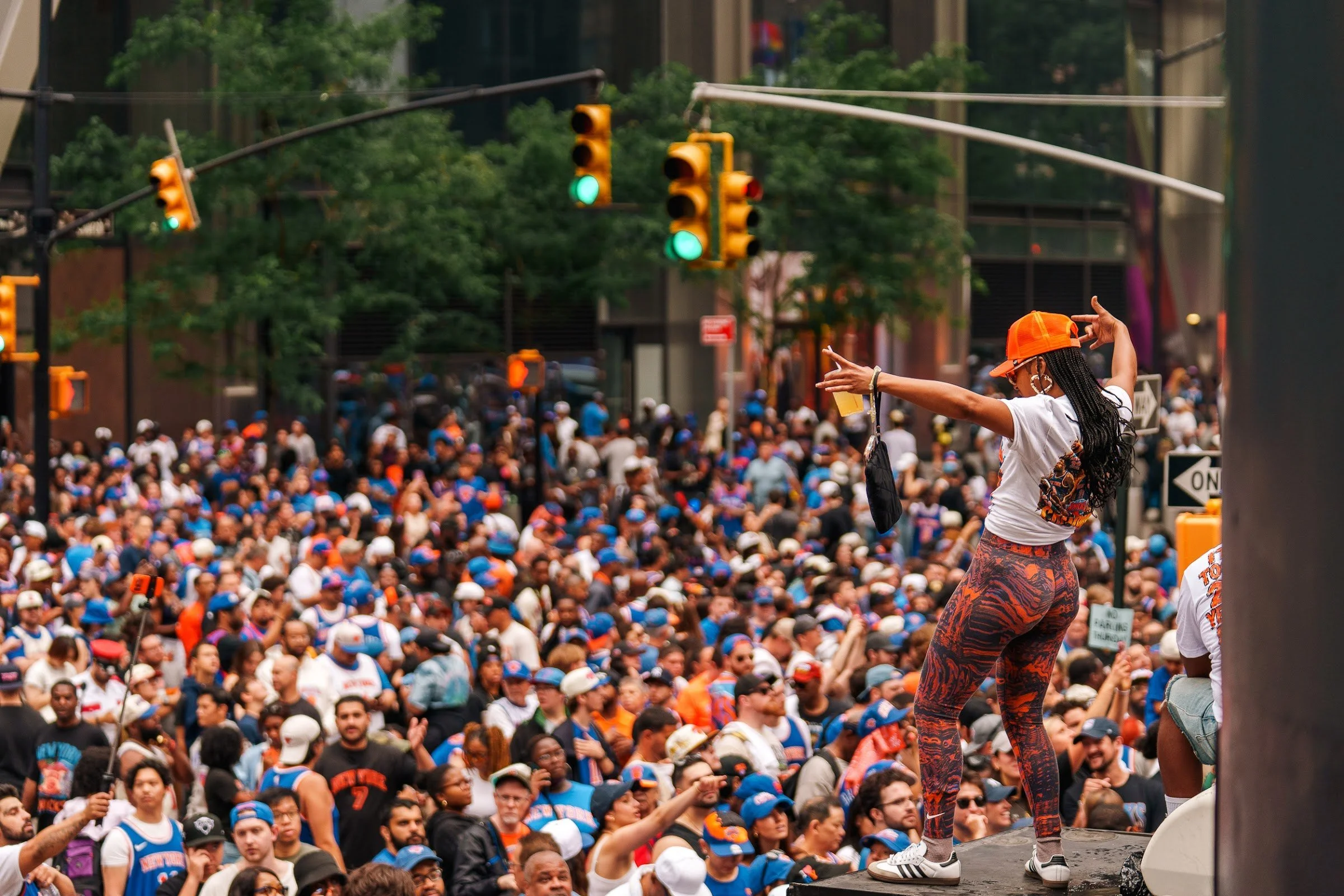 A fan climbing a lamppost for a view