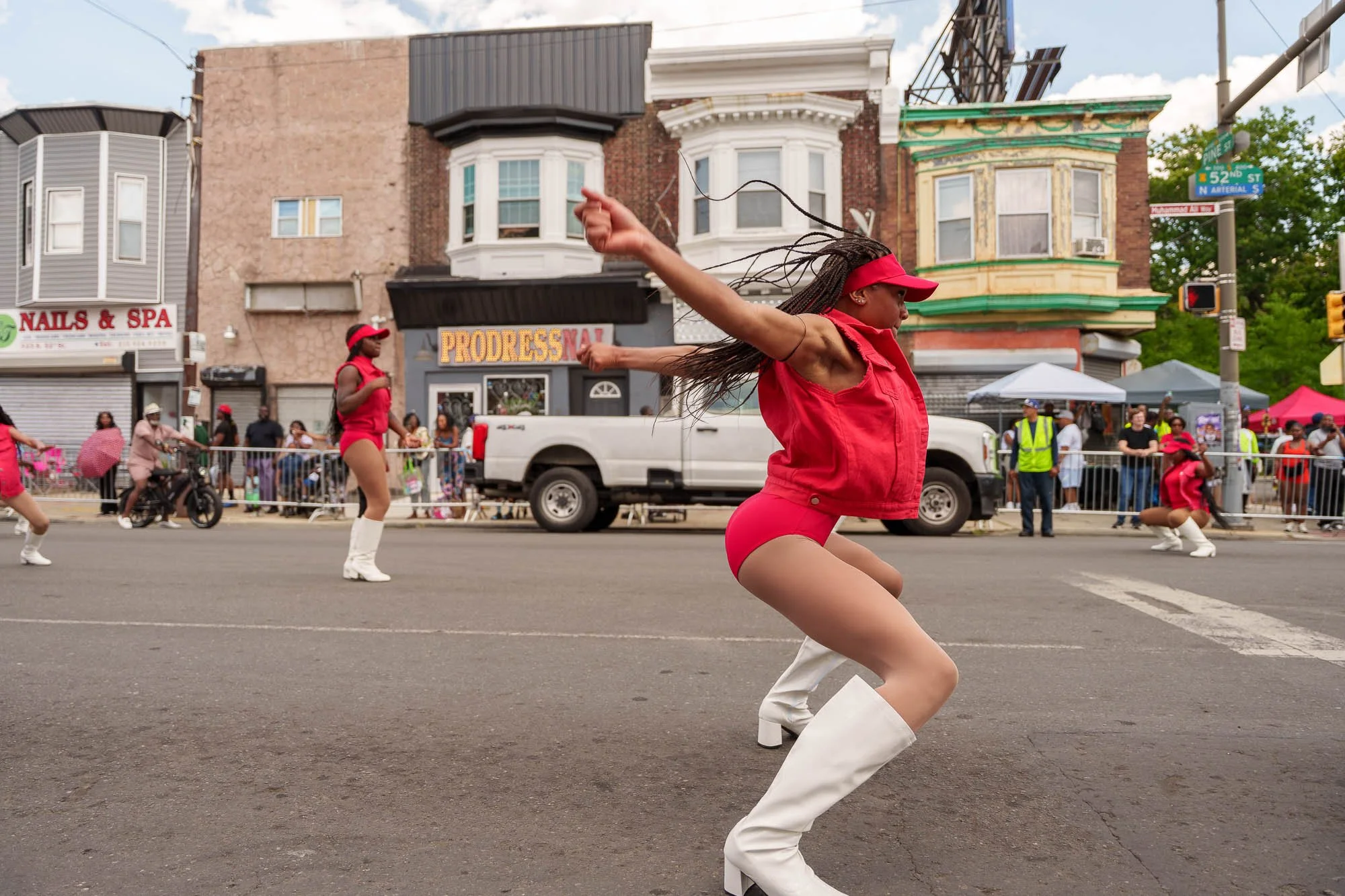 Dancer in red mid-stride on the parade route
