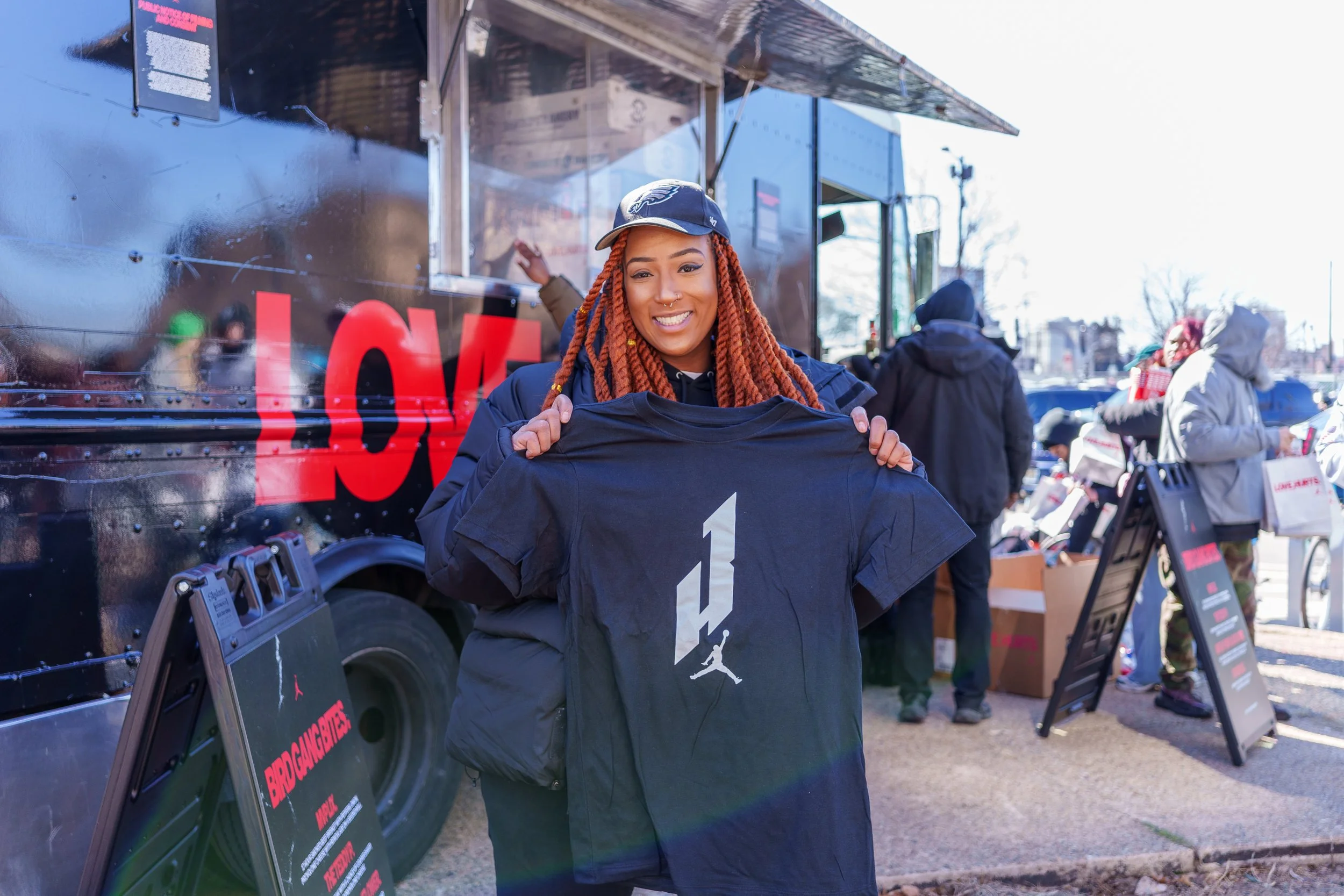 Fan holding up a Jumpman shirt received at the campaign truck