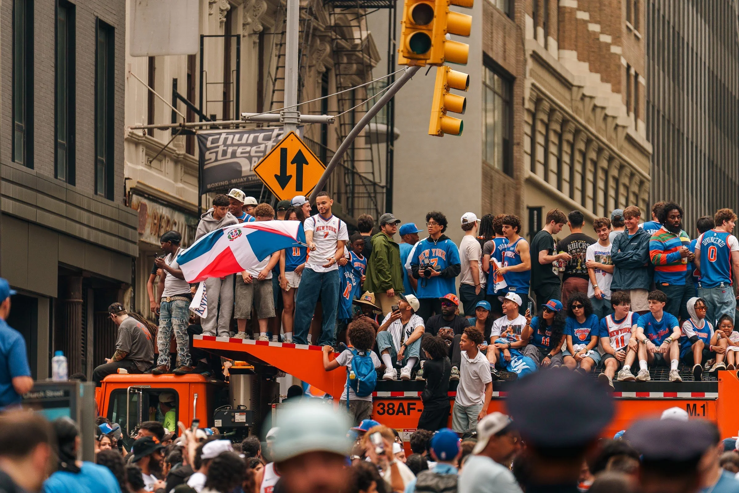 Fans riding a float along the parade route