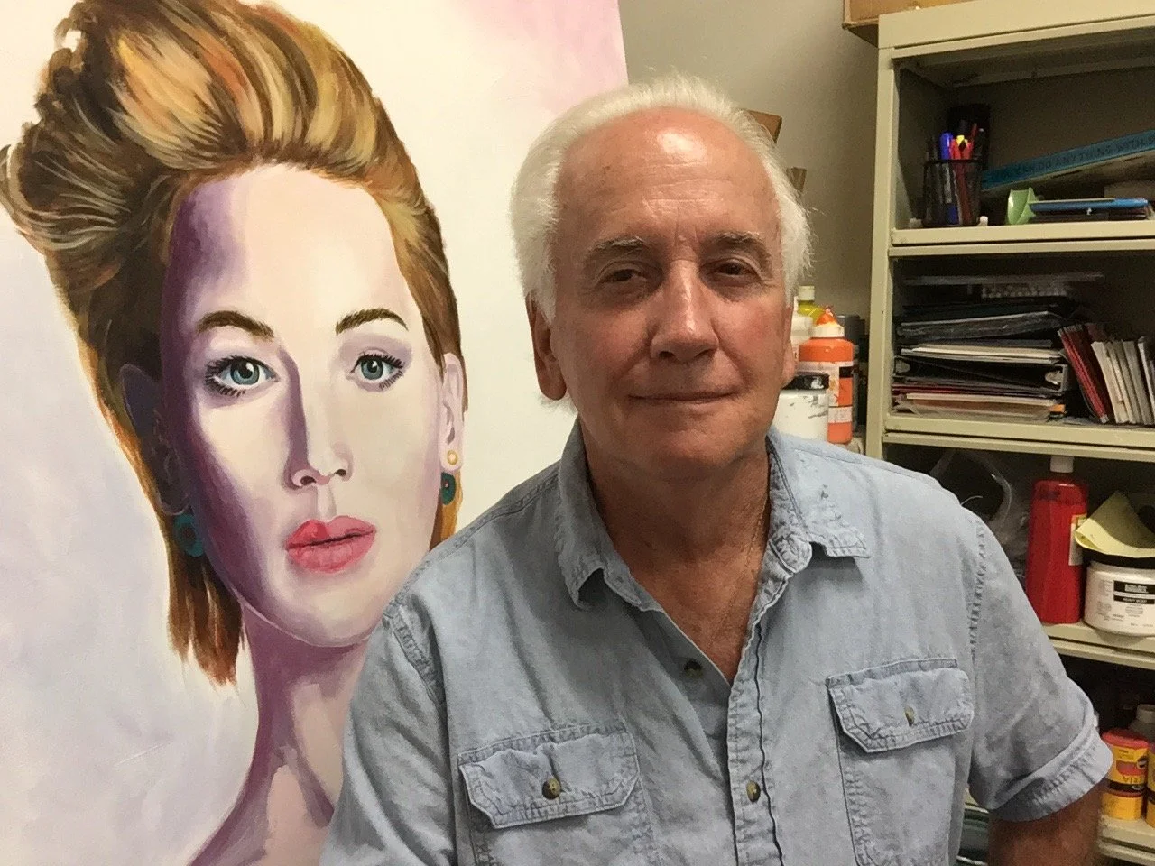Dennis Asbury in his studio with portrait painting