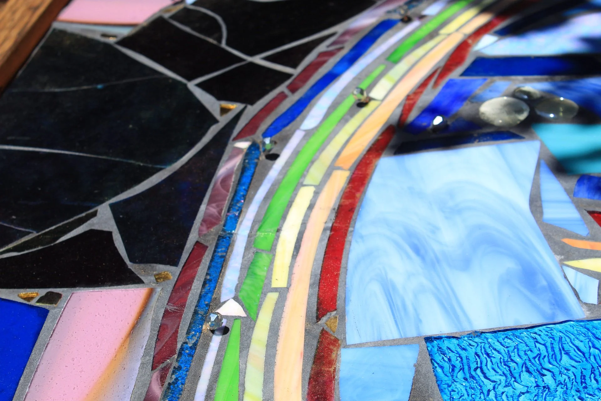 Close-up detail of rainbow glass mosaic work by Miles Mathews