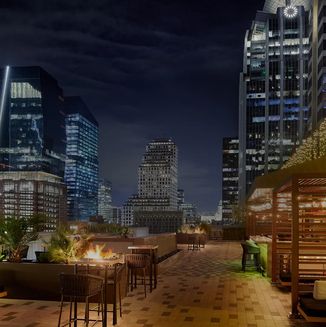 Caroline rooftop at night overlooking downtown Austin