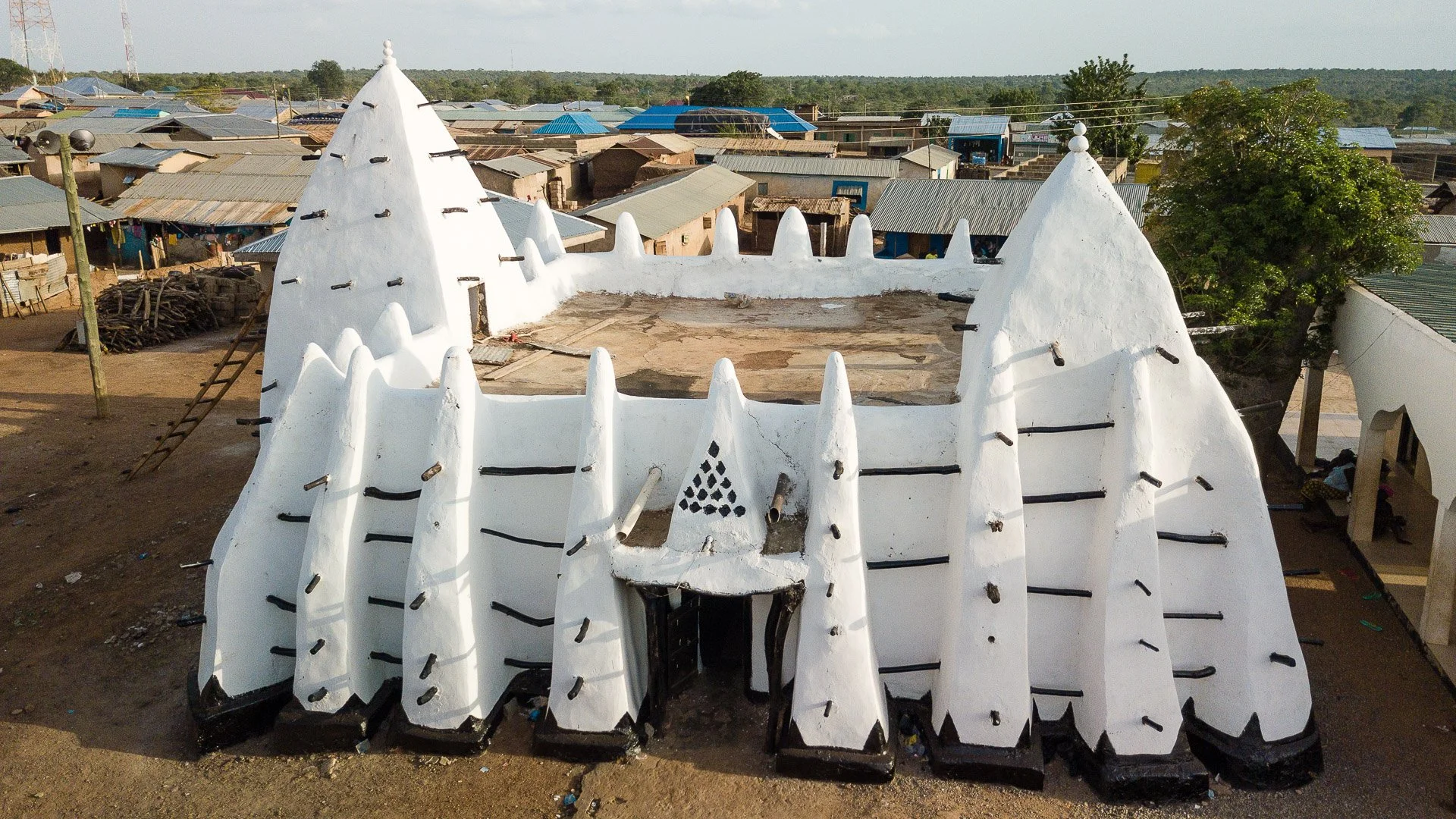 Tamale — mud mosque of Larabanga or savannah landscape at sunset