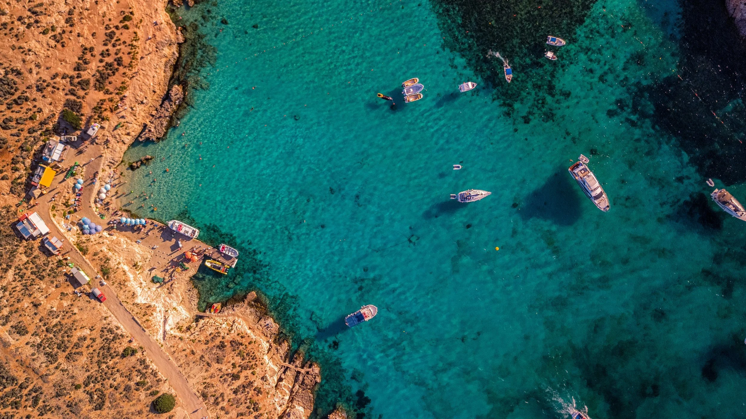 Blue Lagoon Comino turquoise water or Blue Grotto sea caves