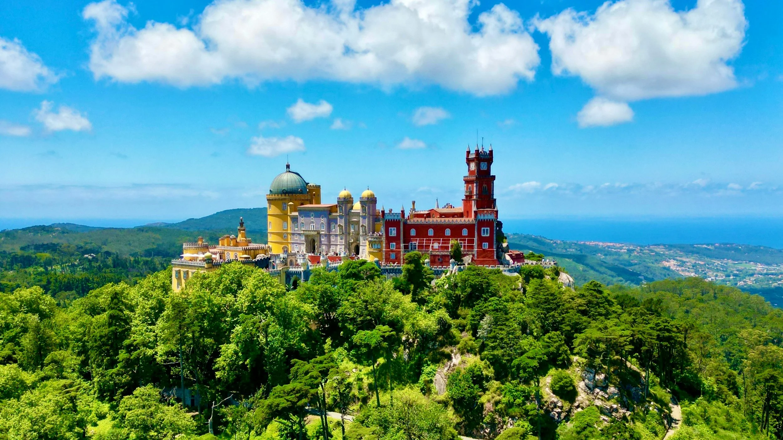 Sintra — Pena Palace rising above the forested hills