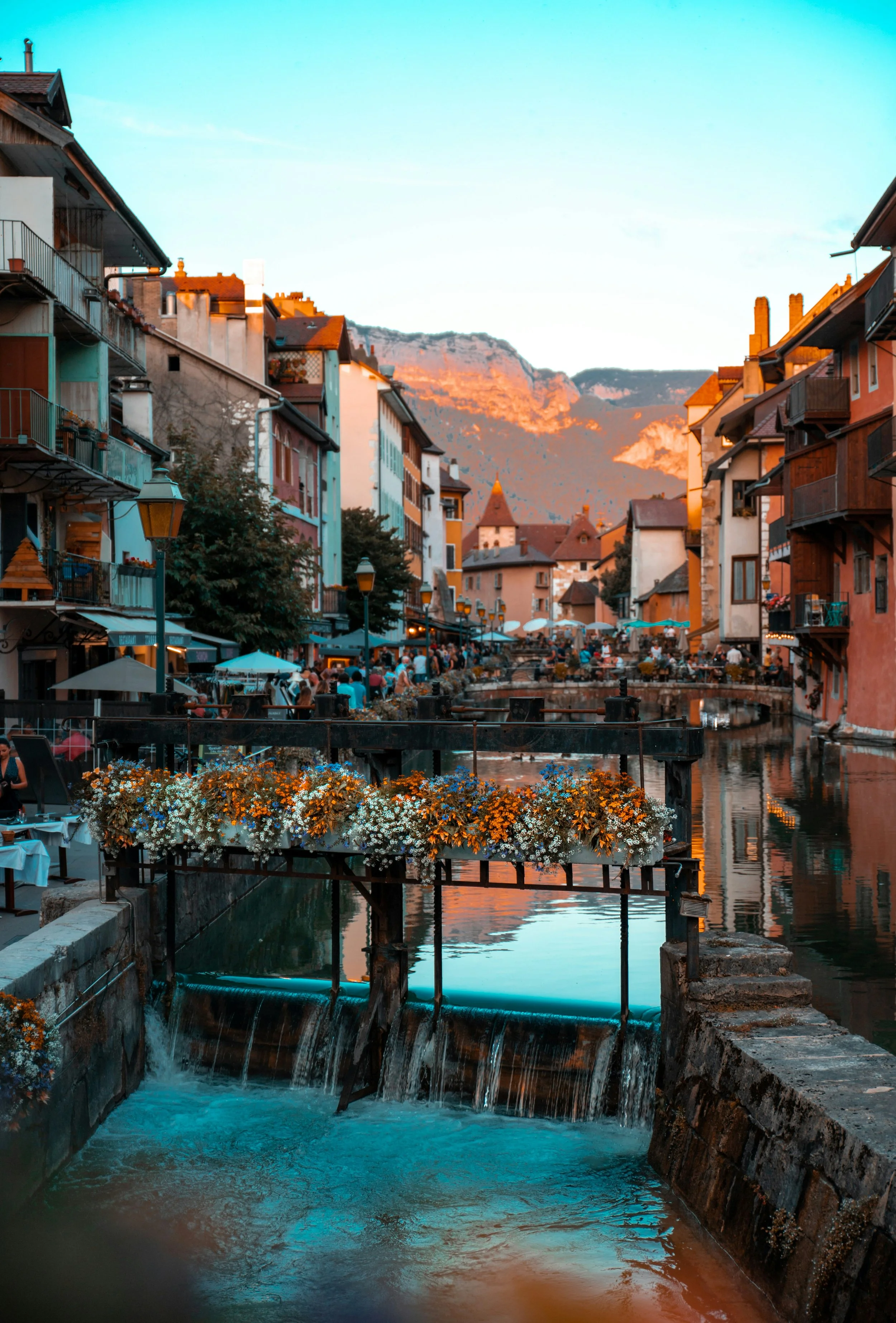 Annecy — old town canals with flower-lined bridges and the Alps behind