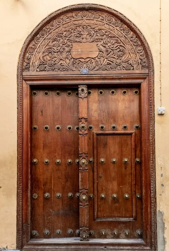 Zanzibar — Stone Town carved doorways or turquoise water at Nungwi