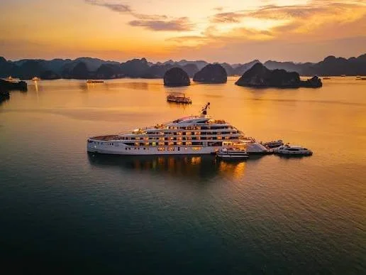 Halong Bay — limestone karsts from the water or luxury junk at sunset