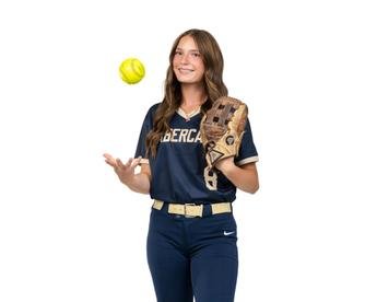 Kate Seaton posing with a softball and glove