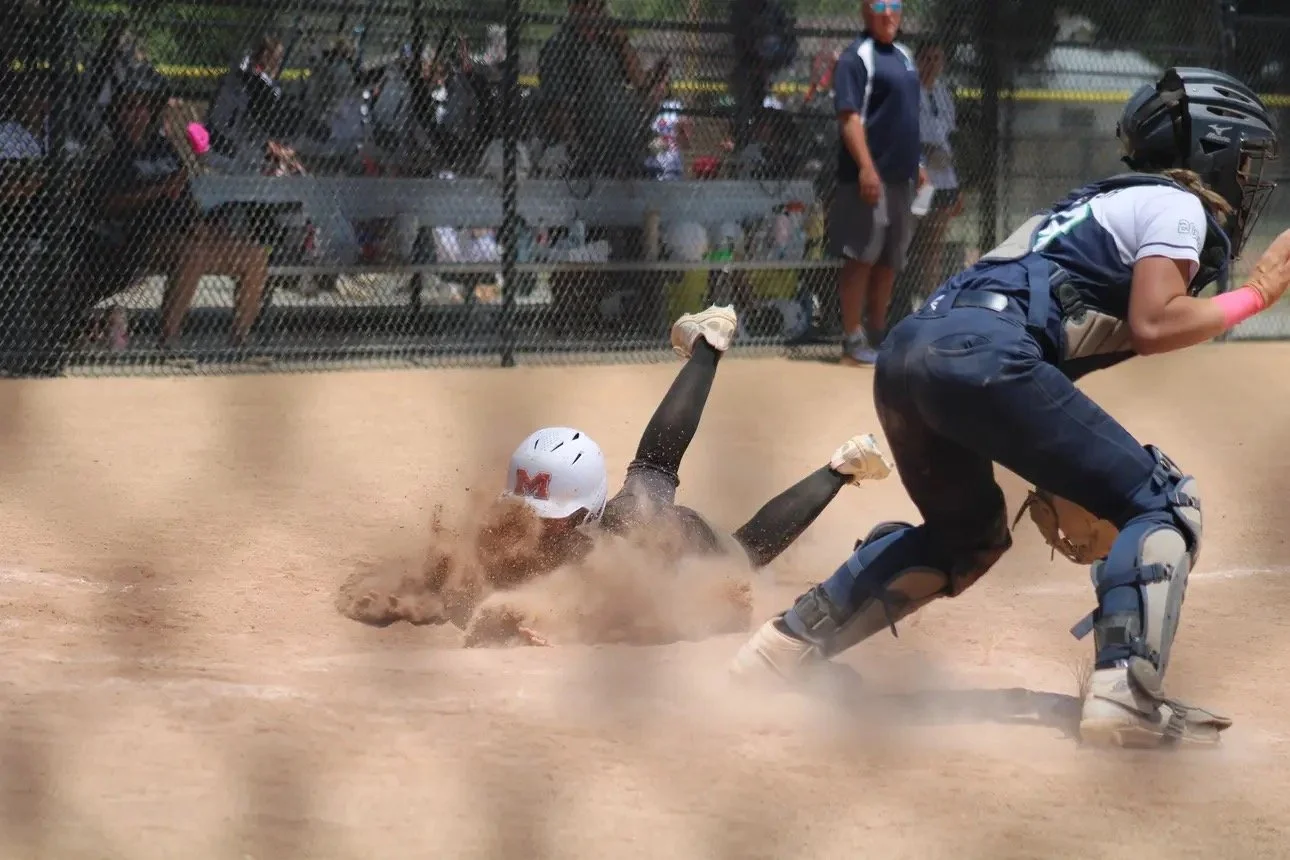 Payton Detweiler sliding into home plate