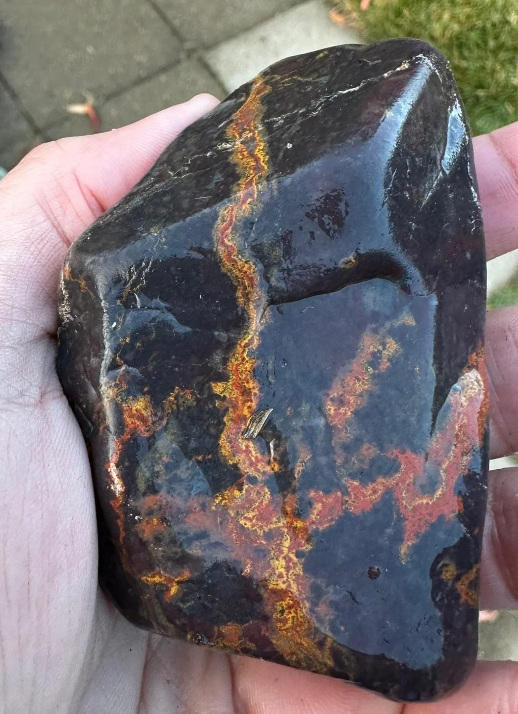 Dark purple jasper with glowing orange and yellow veins
