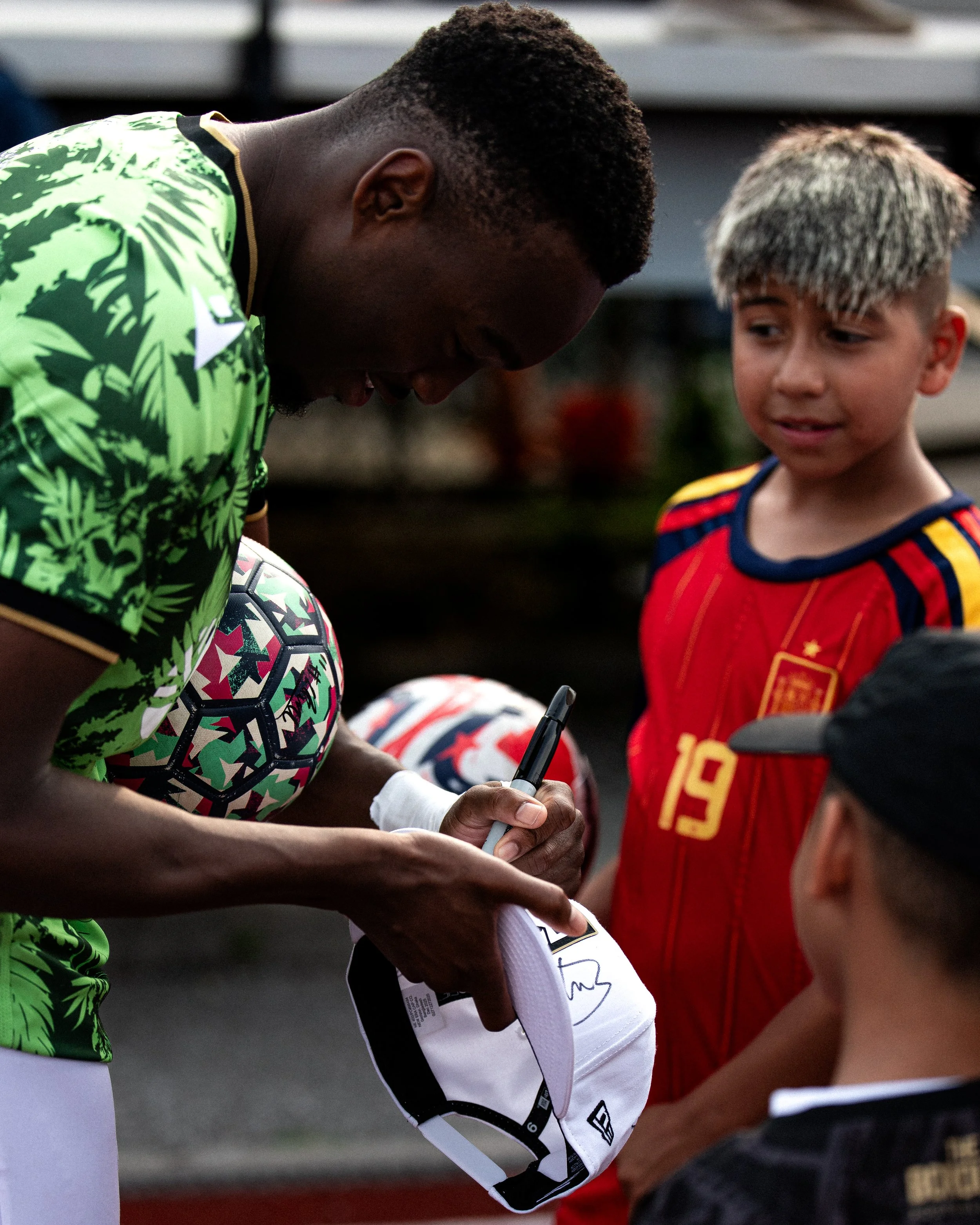Borough FC player interacting with young football supporters