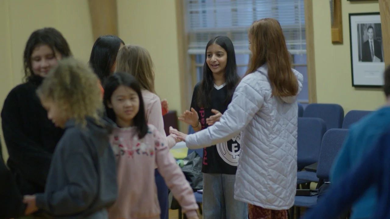 Elementary choir singers rehearsing together
