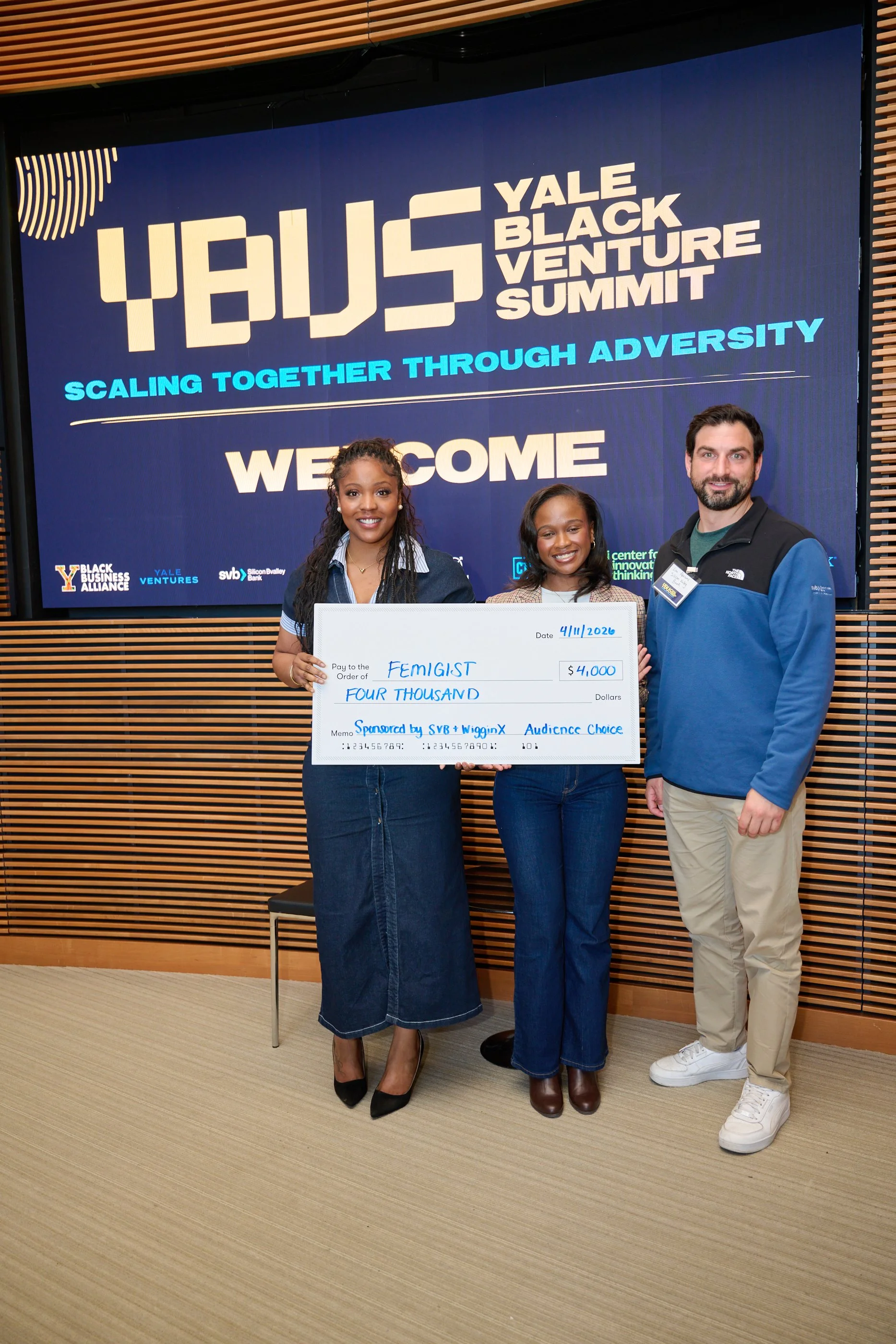 Summit participant holding a pitch competition award