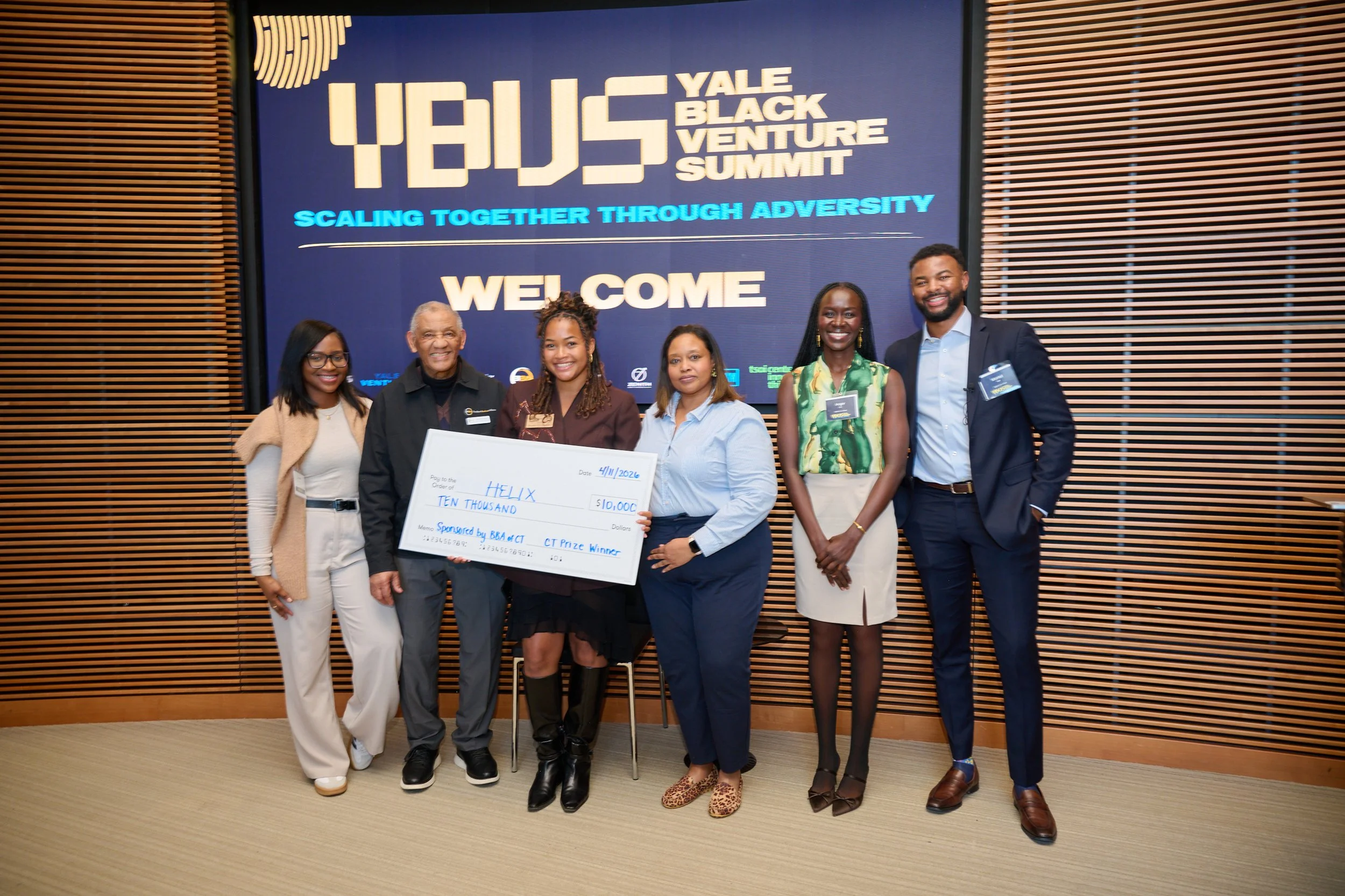 Summit participants celebrating an award on stage
