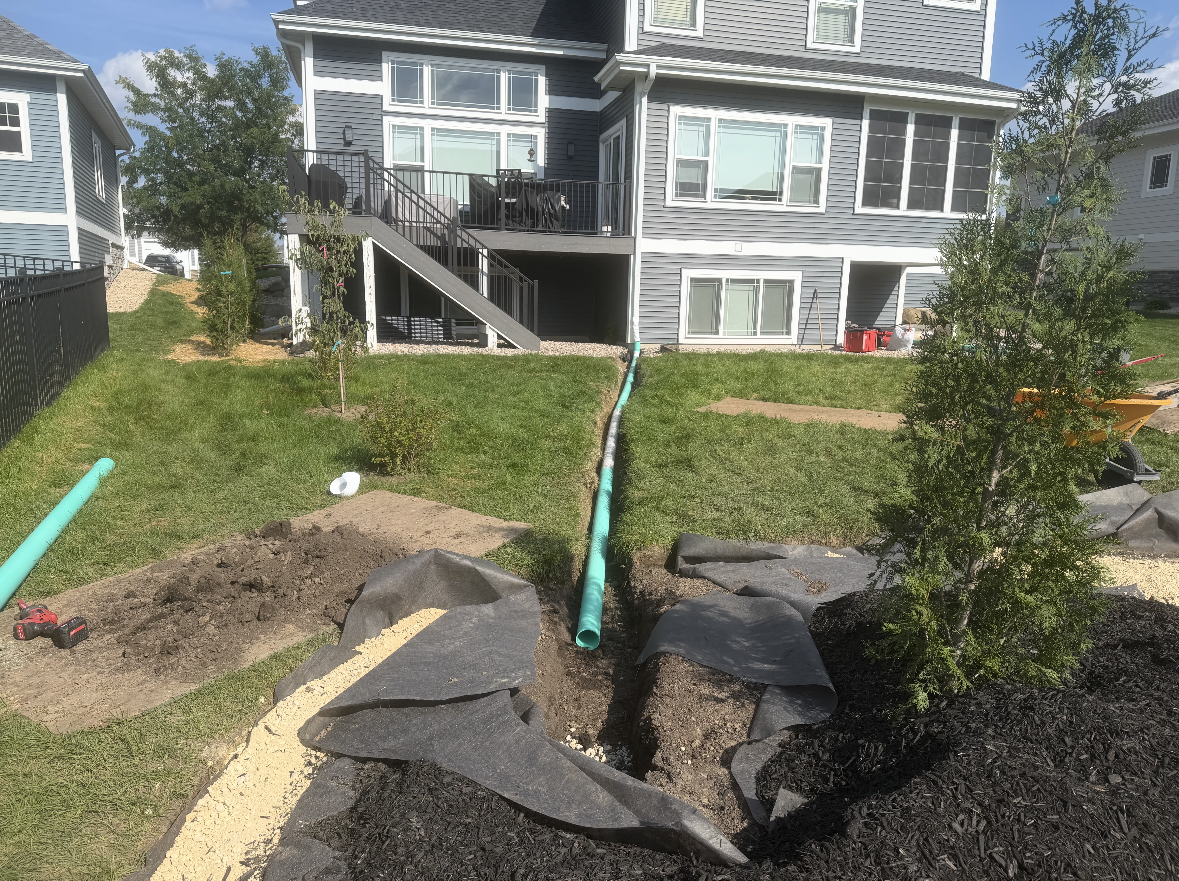 Buried downspout extension installed in a residential yard