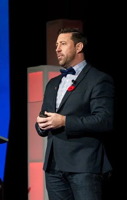 Jim Moss speaking to a conference audience about trust and leadership