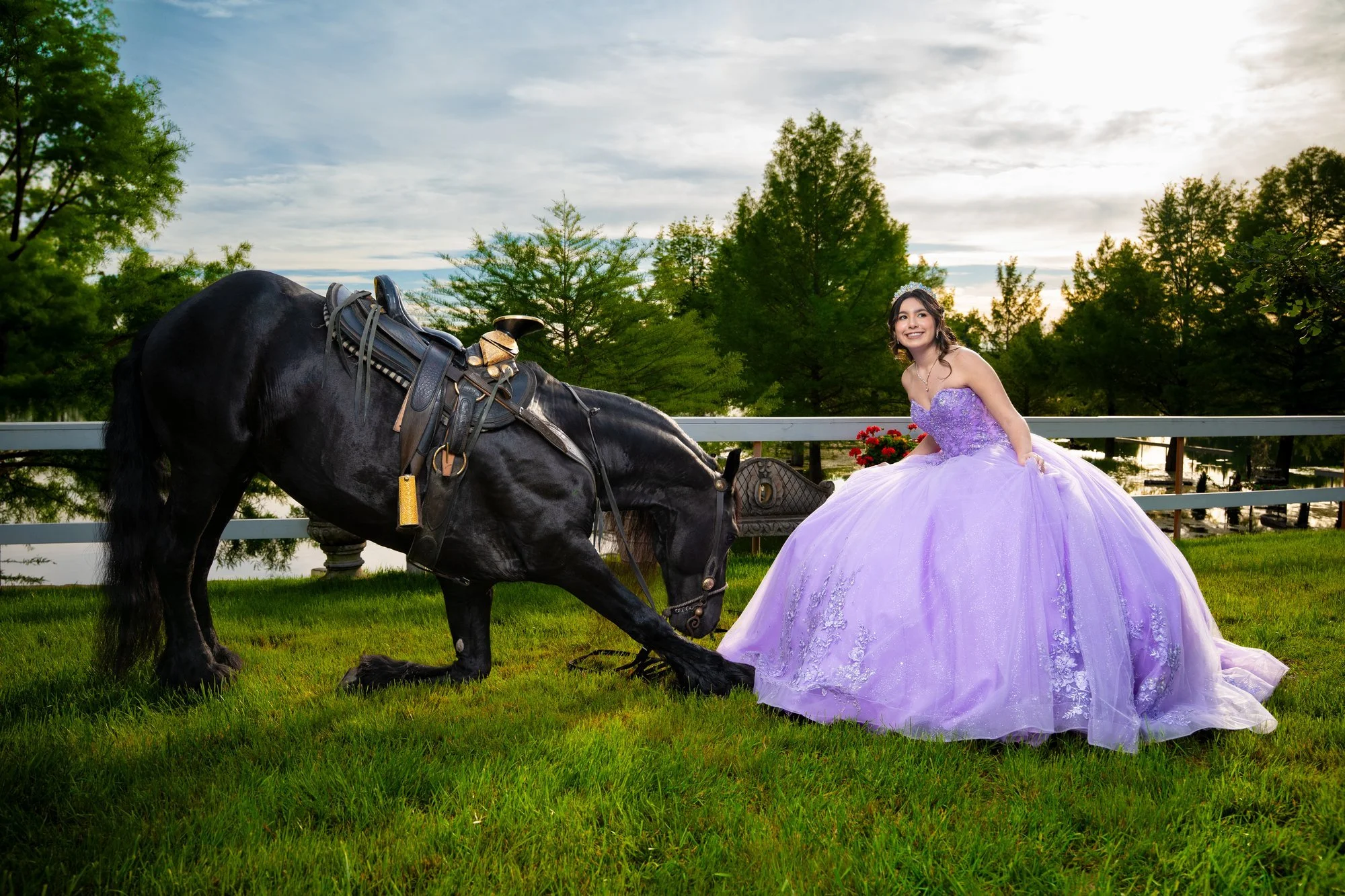 Quinceañera walking a black horse during a DFW photoshoot