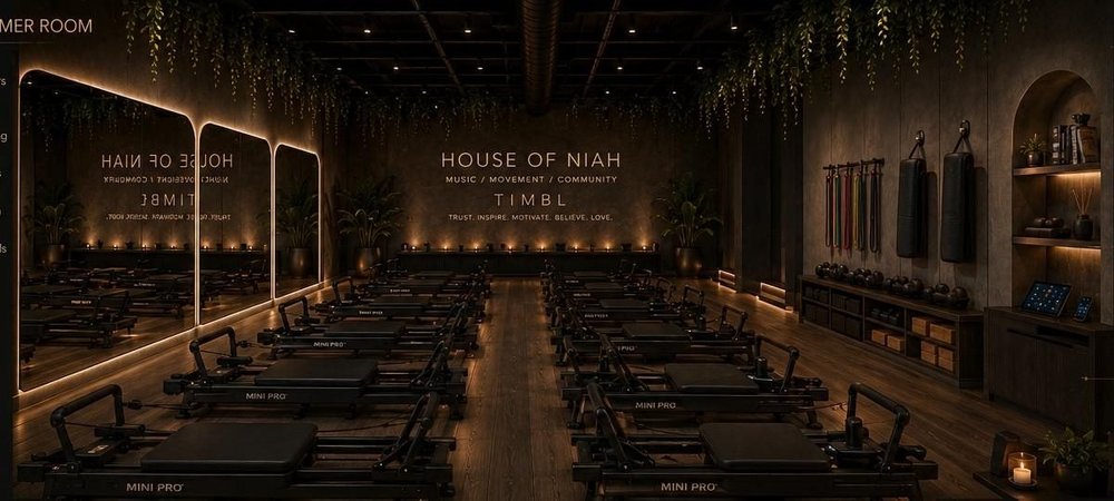 Concept render of the reformer room with rows of reformer machines, arched mirrors, and candlelight.