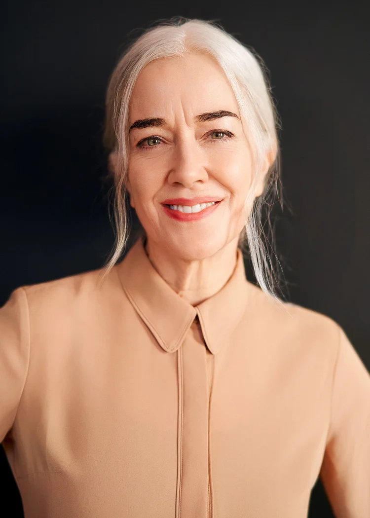 Actor headshot of a woman with silver hair smiling warmly, NYC