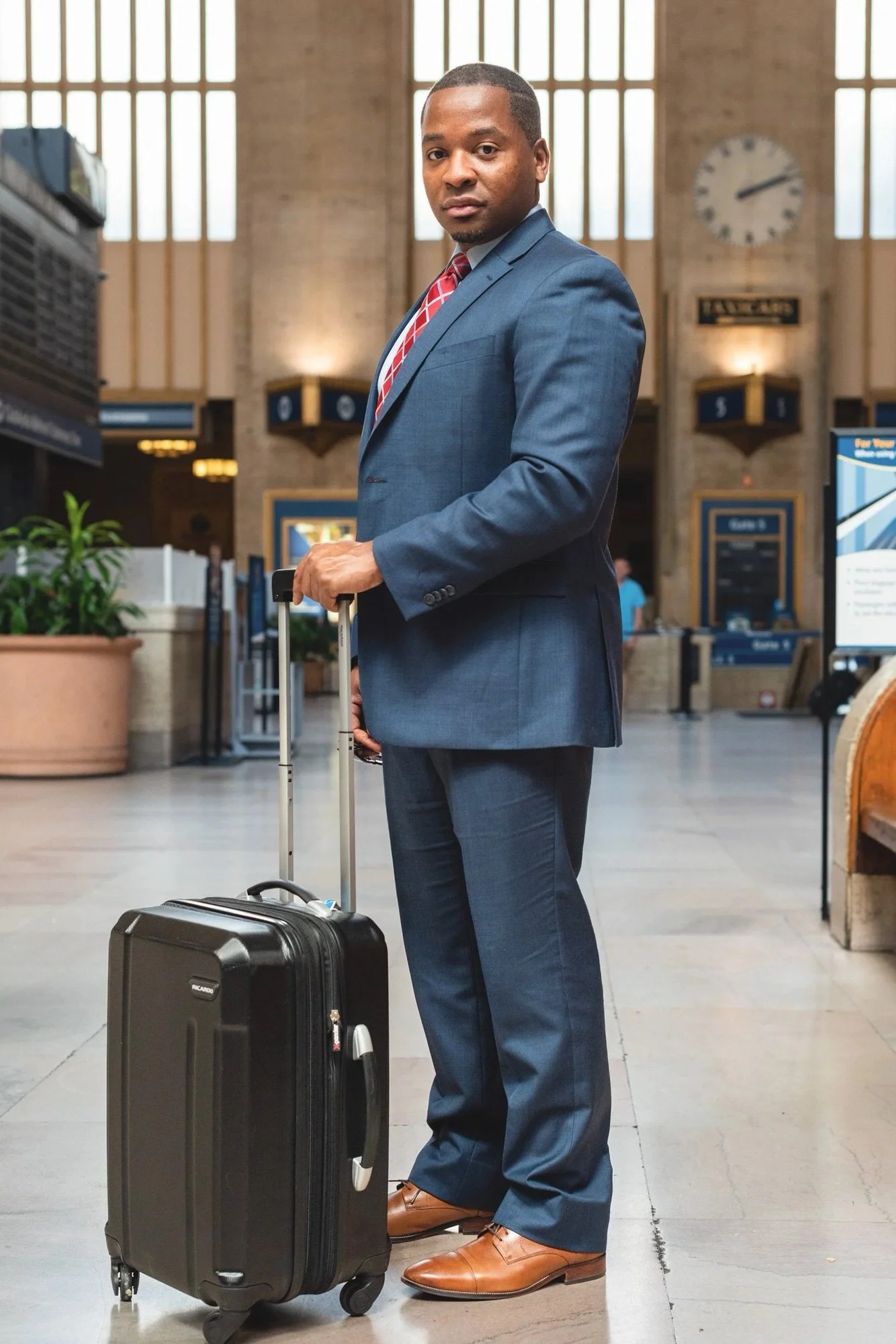 Business lifestyle photography NYC man in suit with luggage professional corporate photoshoot New York David Pexton Photography