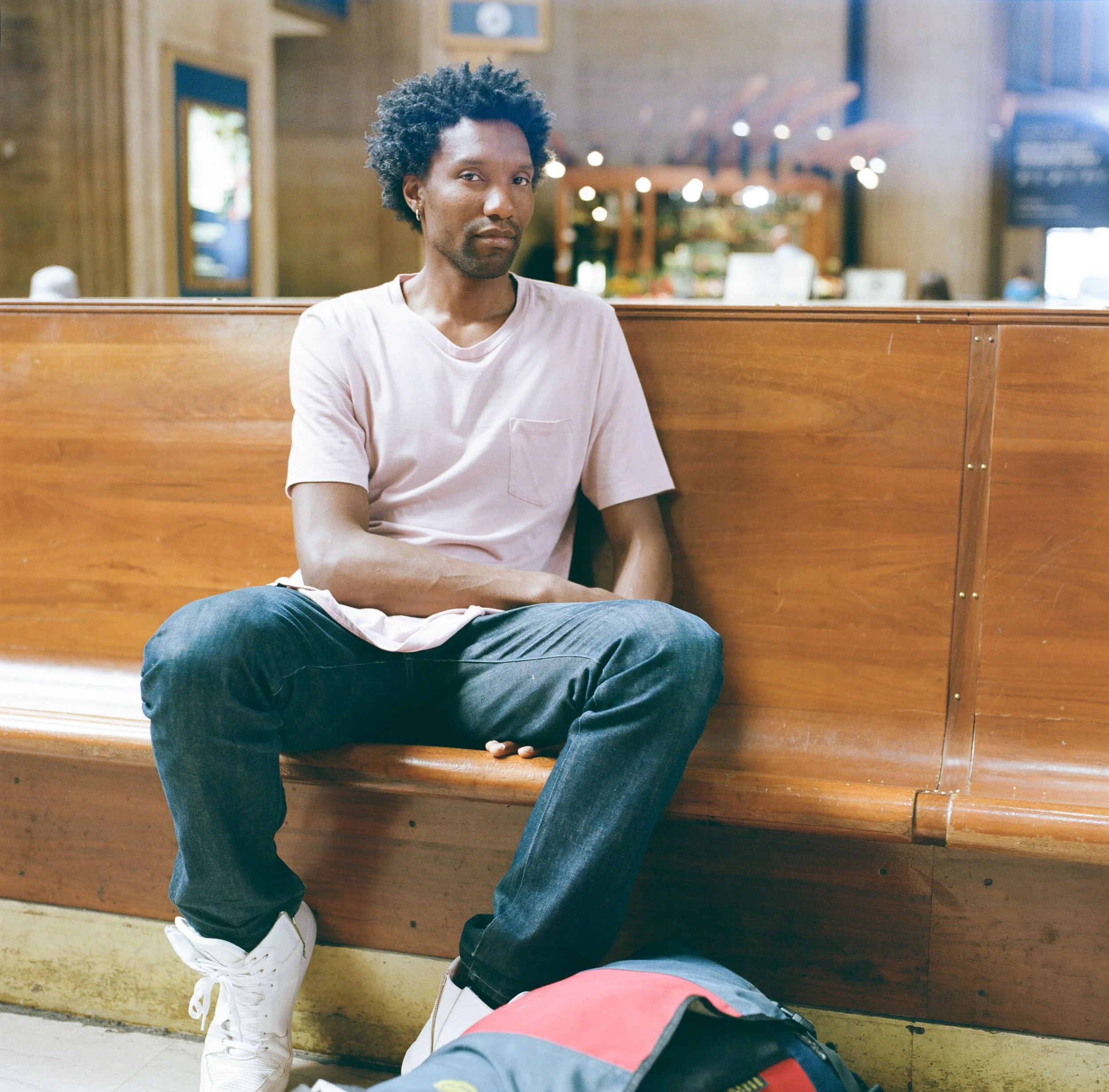 Corporate portrait photography NYC man seated grand hall train station editorial David Pexton Photography