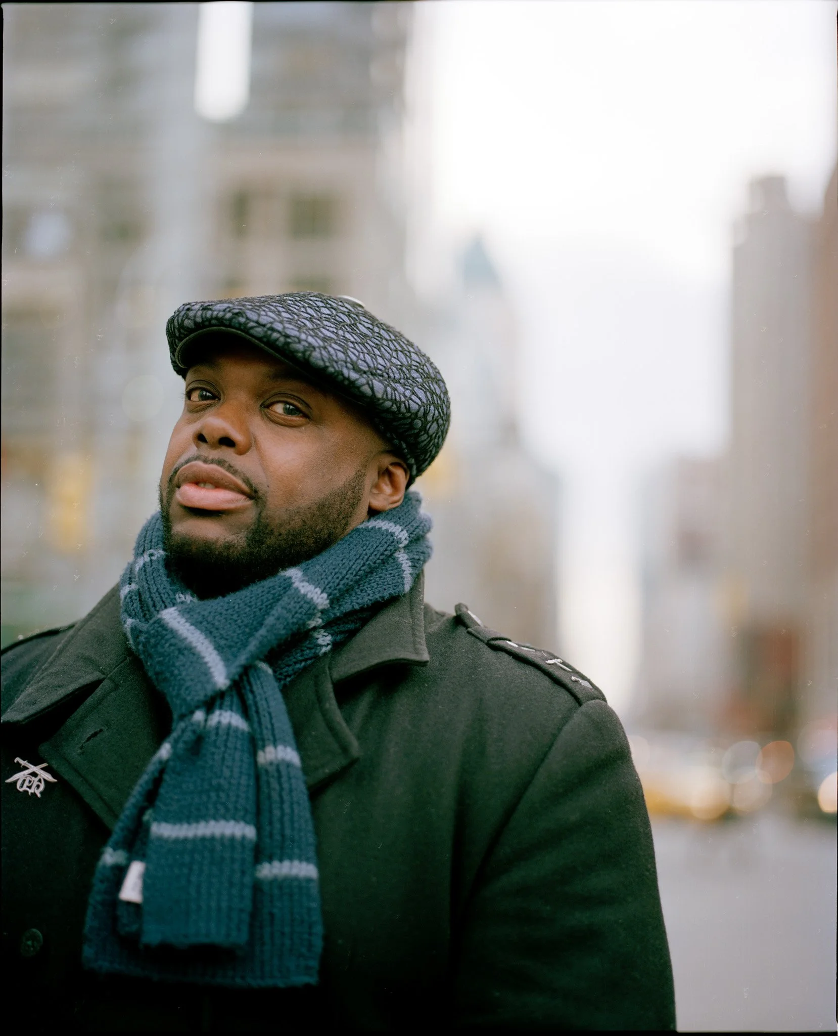 Jemini the Gifted One in a winter street portrait, looking toward the camera in New York City