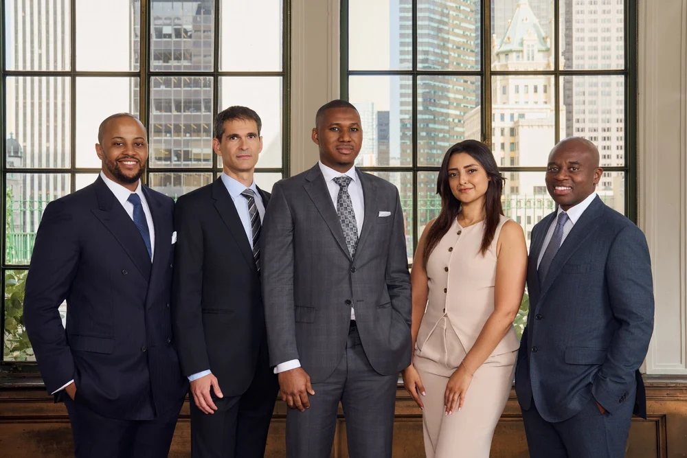 Corporate leadership group portrait of five executives in a New York office