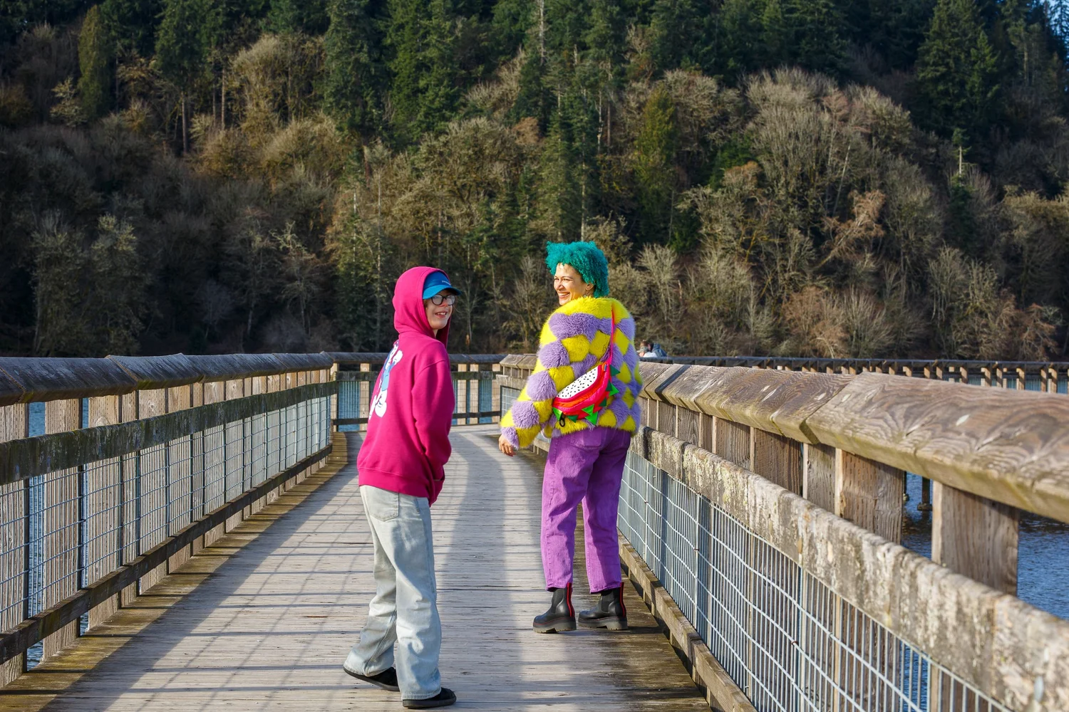 Two visitors in bright jackets walk the boardwalk at Nisqually National Wildlife Refuge near Olympia