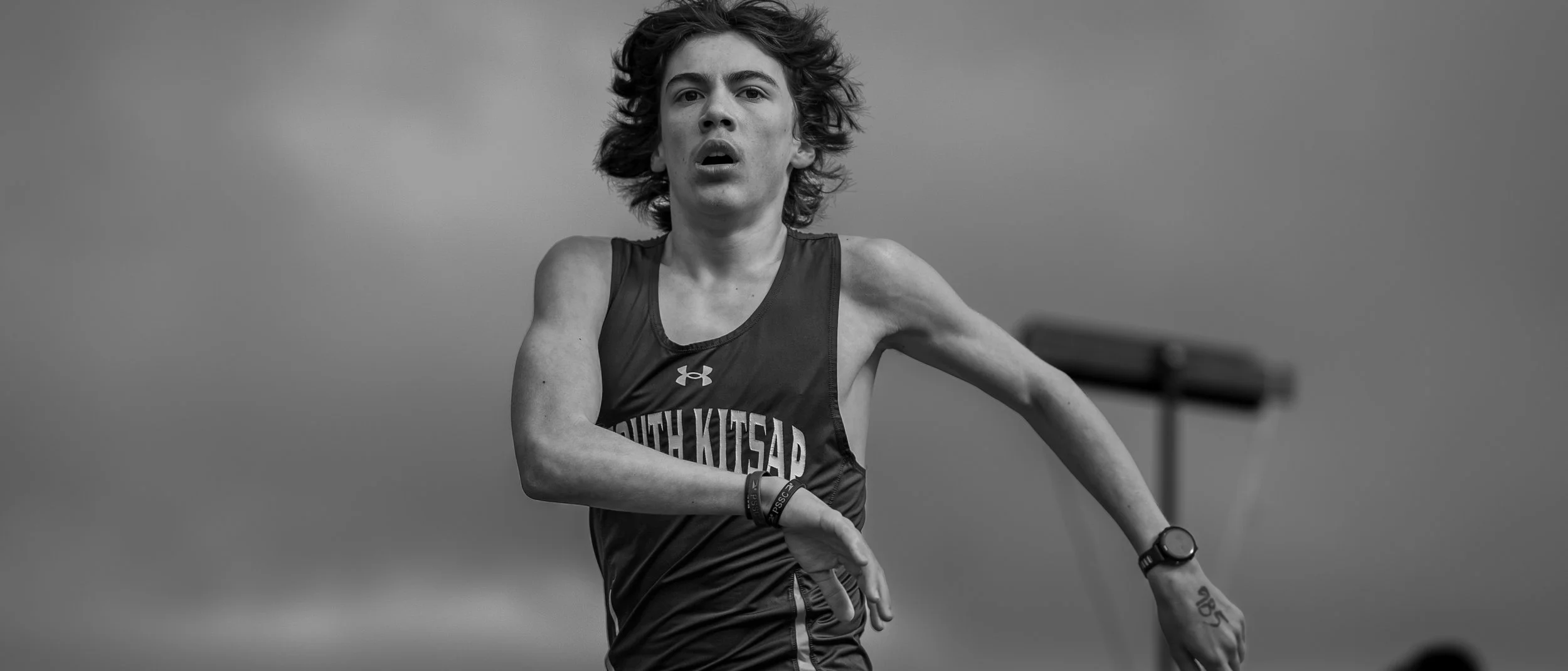 South Kitsap High School male track athlete running the 1600m.