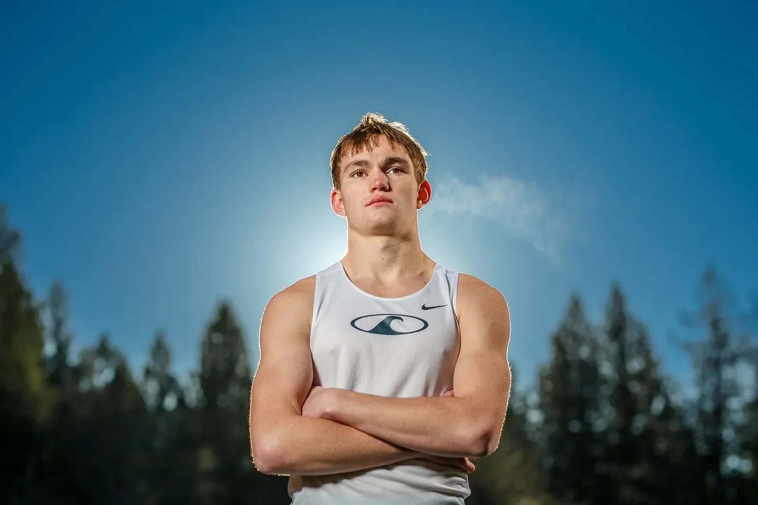 Athlete Max Dower photographed from a low angle against blue sky