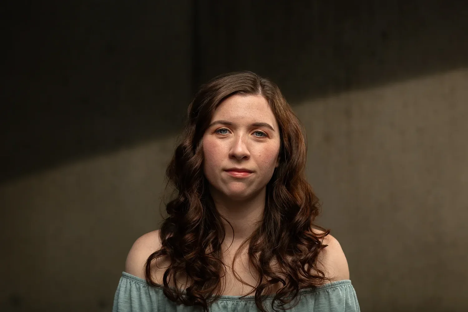 Headshot photographed against a concrete backdrop in Olympia, Washington