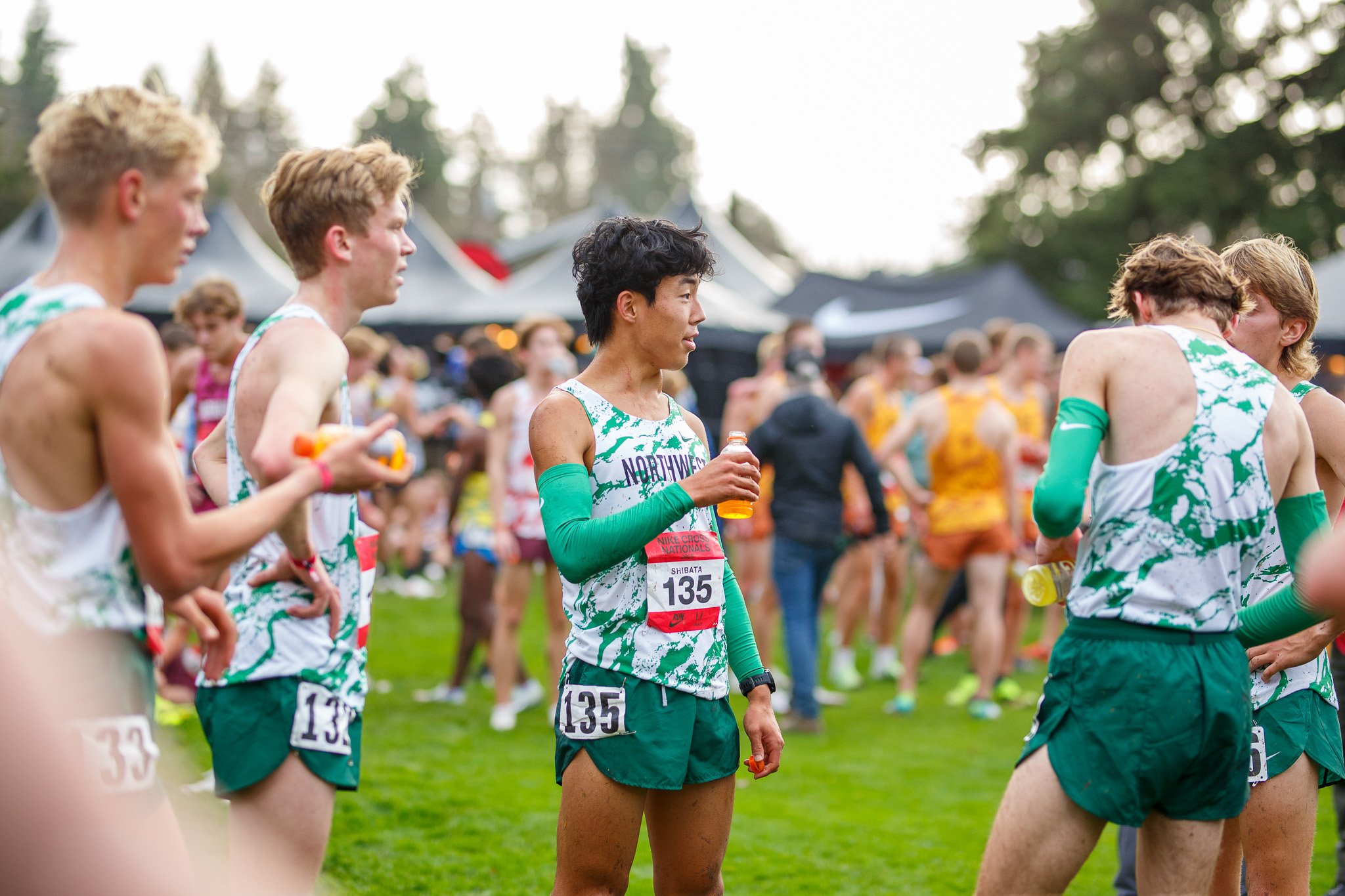 Athletes cresting the rolling hills on the national championship cross country course in Portland, Oregon.