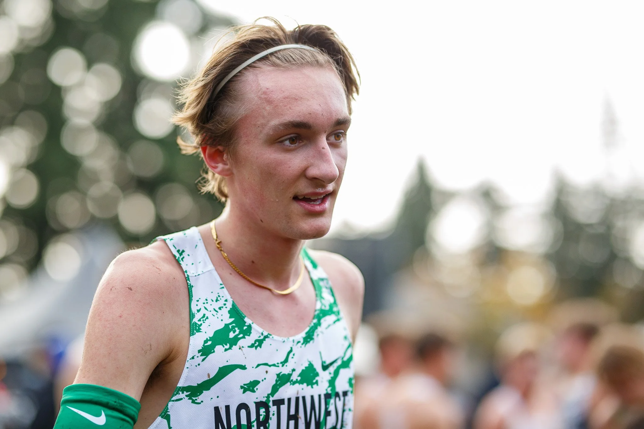Mud flying off the spikes of an elite runner during the 2025 Nike Cross Nationals (NXN) at Glendoveer.