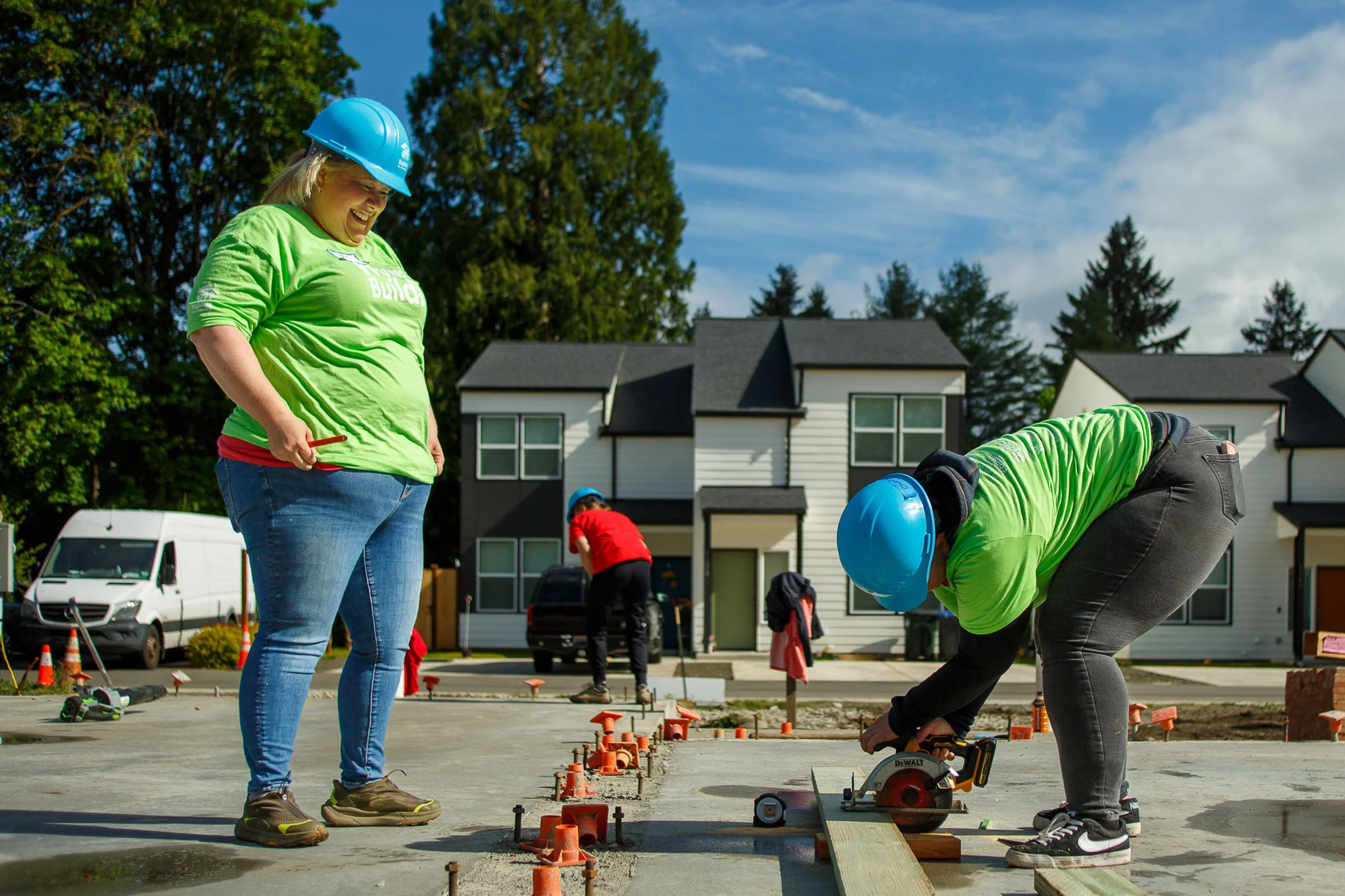 The Swire Coca-Cola team measures and preps building material during the South Puget Sound Habitat for Humanity Women Build
