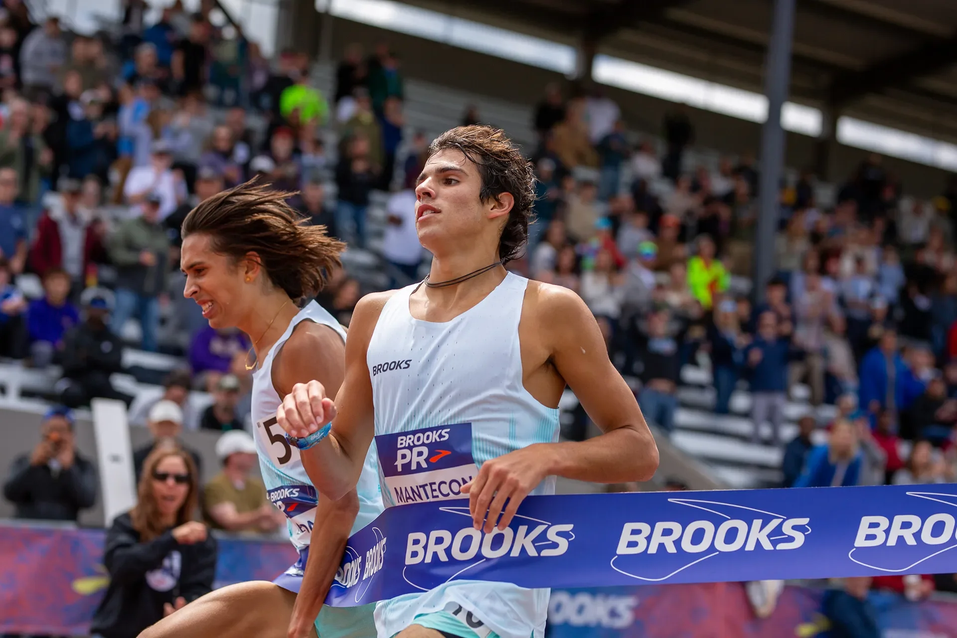 Marcelo Mantecon breaking the tape to win the Boys 2 Mile