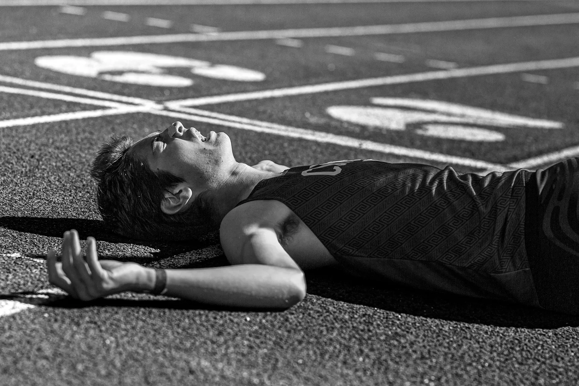 Owen Mangrum of Curtis lies on the track after the 1600m at the 2026 districts
