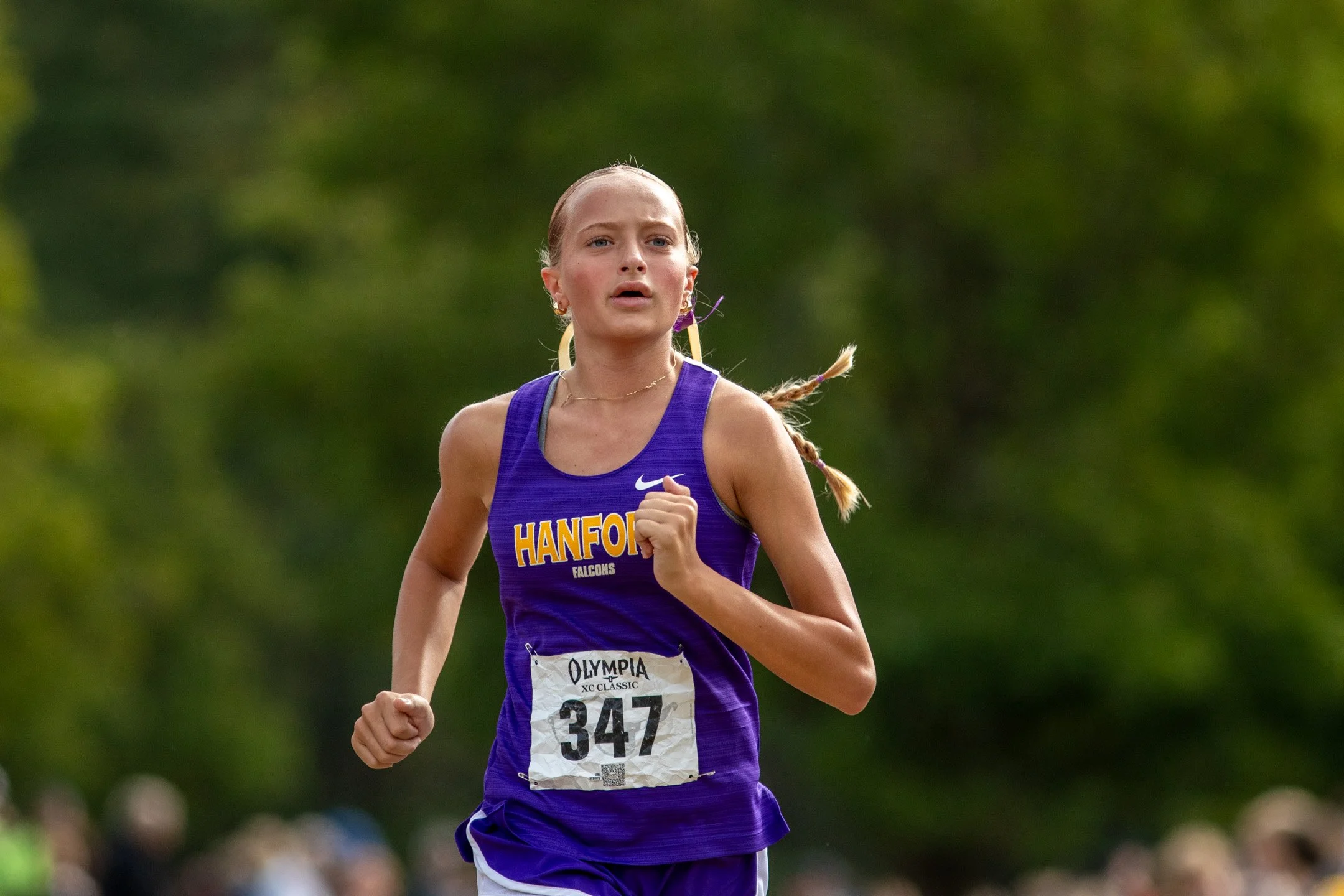 Girl in purple Hanford jersey, bib 347, running alone at the 2026 Olympia XC Classic.