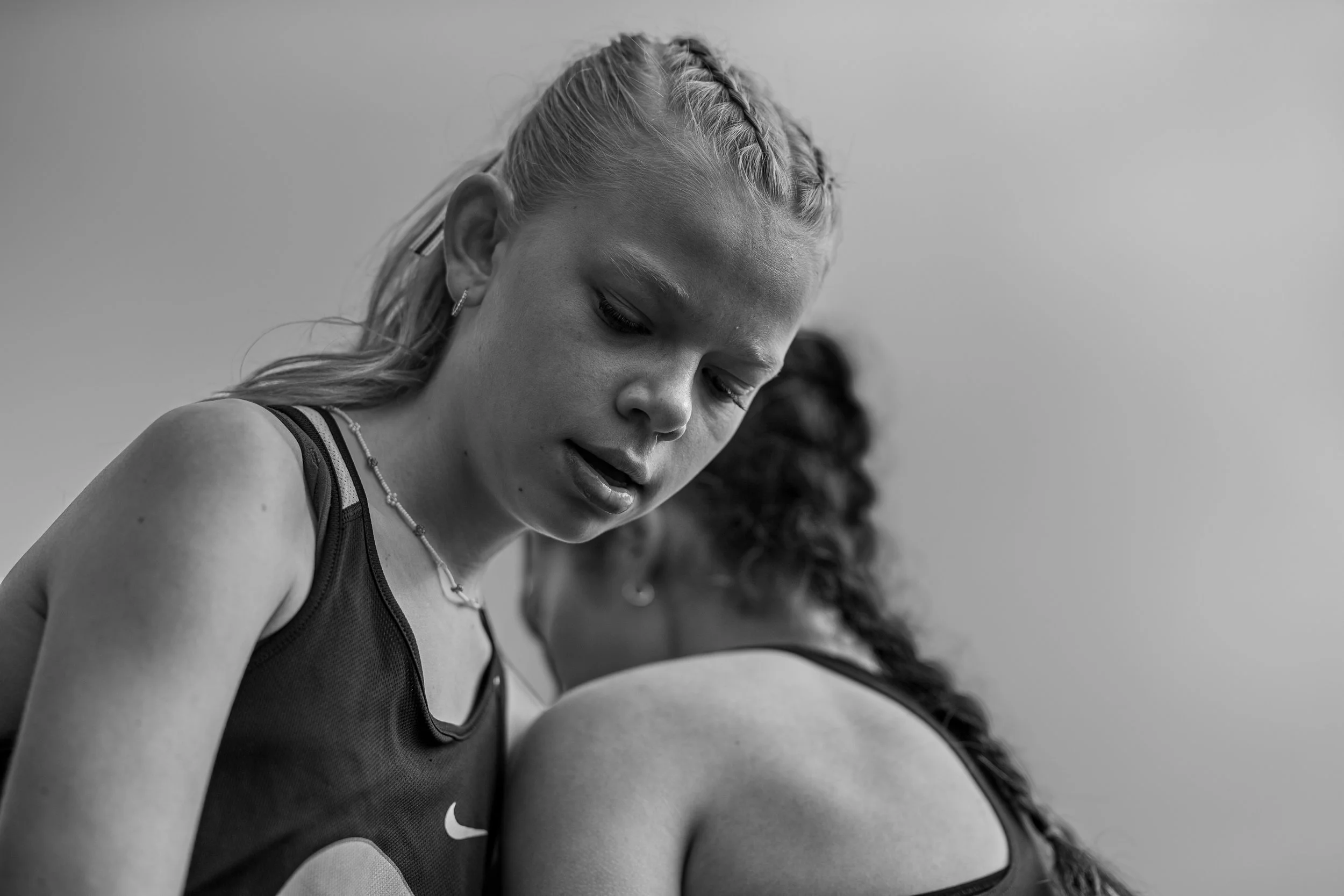Gritty monochrome portrait of Eliza Johnson, Olympia High School track athlete.
