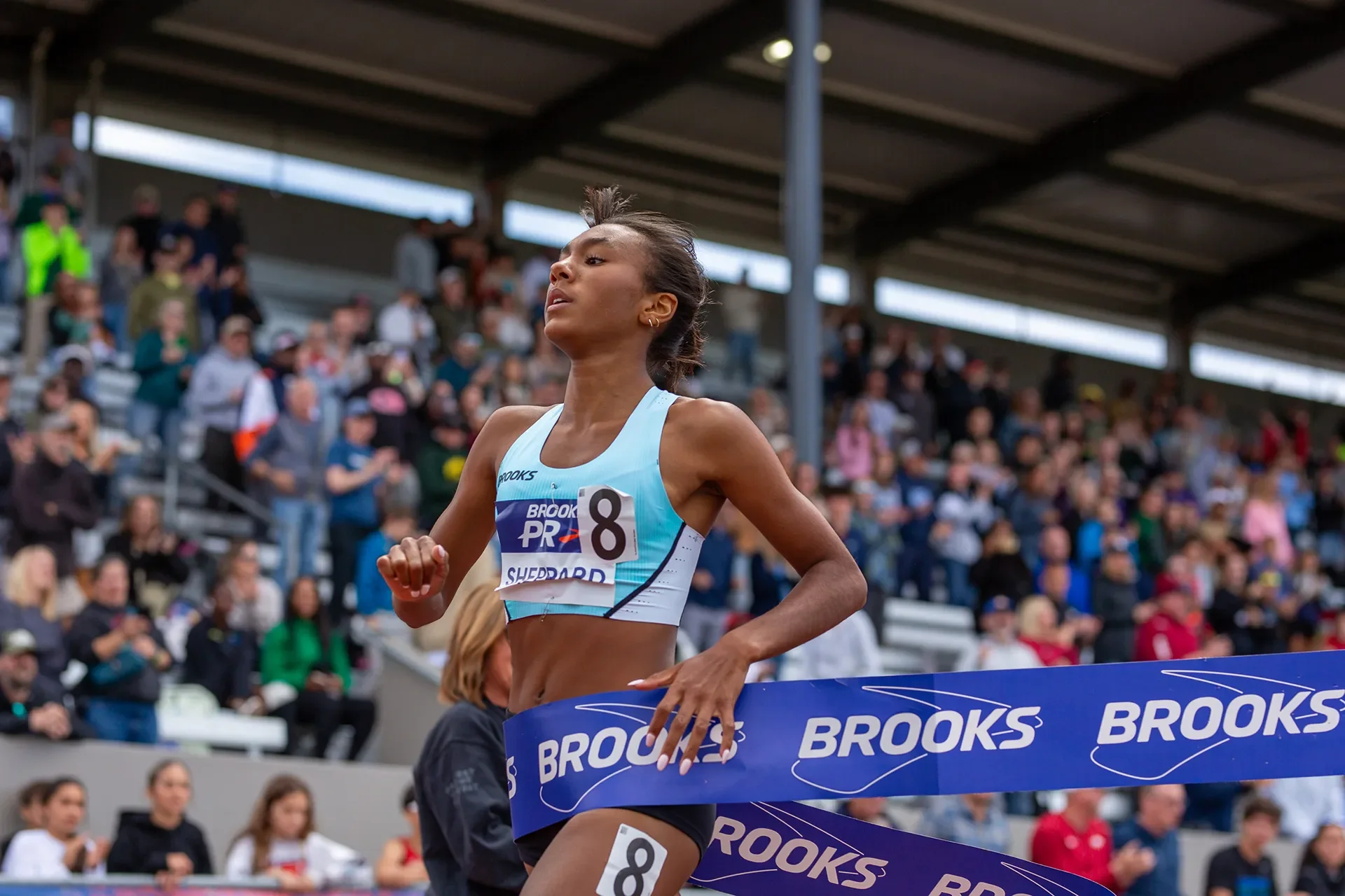 Paige Sheppard executing a sprint finish to win the Girls 800 Meters