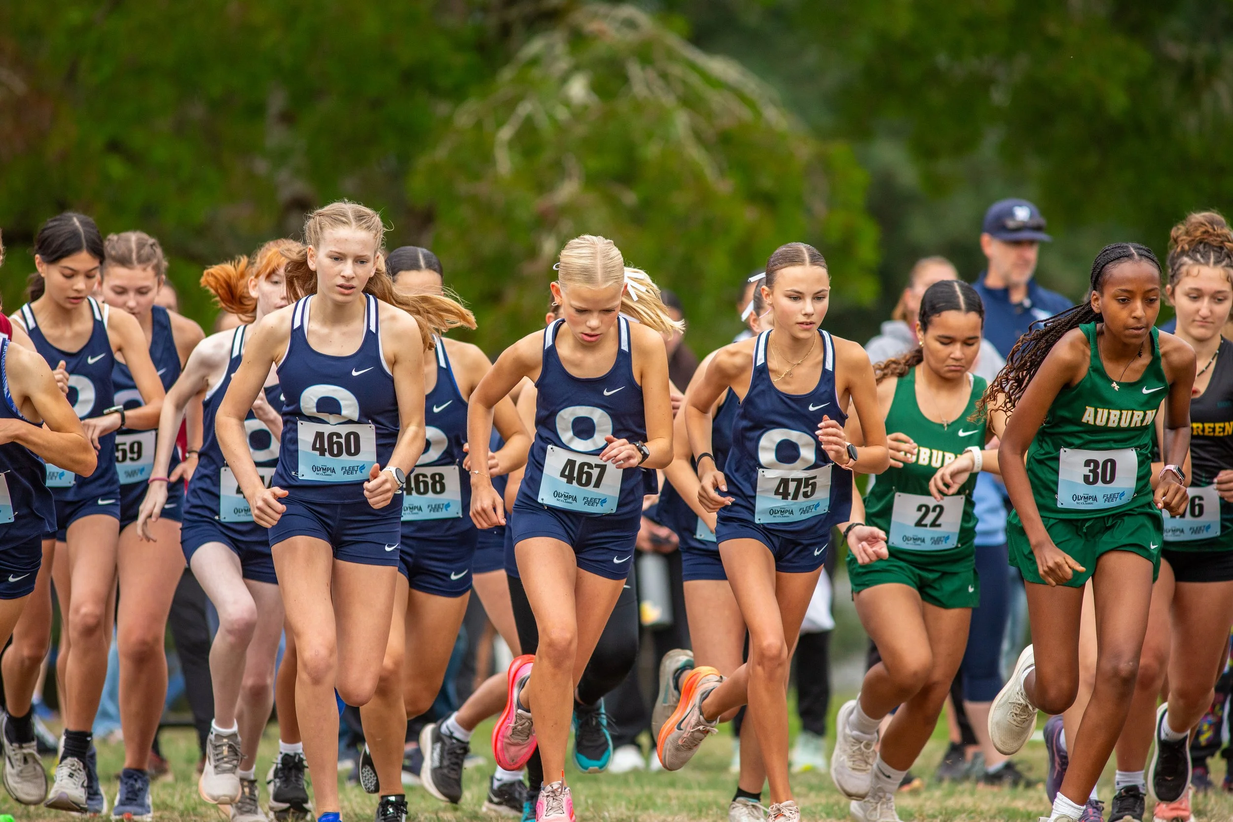 Caitlin Lanese, Eliza Johnson and Leah Hennen lead the Olympia High School freshman girls off the line at the 2025 Olympia XC Classic, LBA Park, Olympia WA